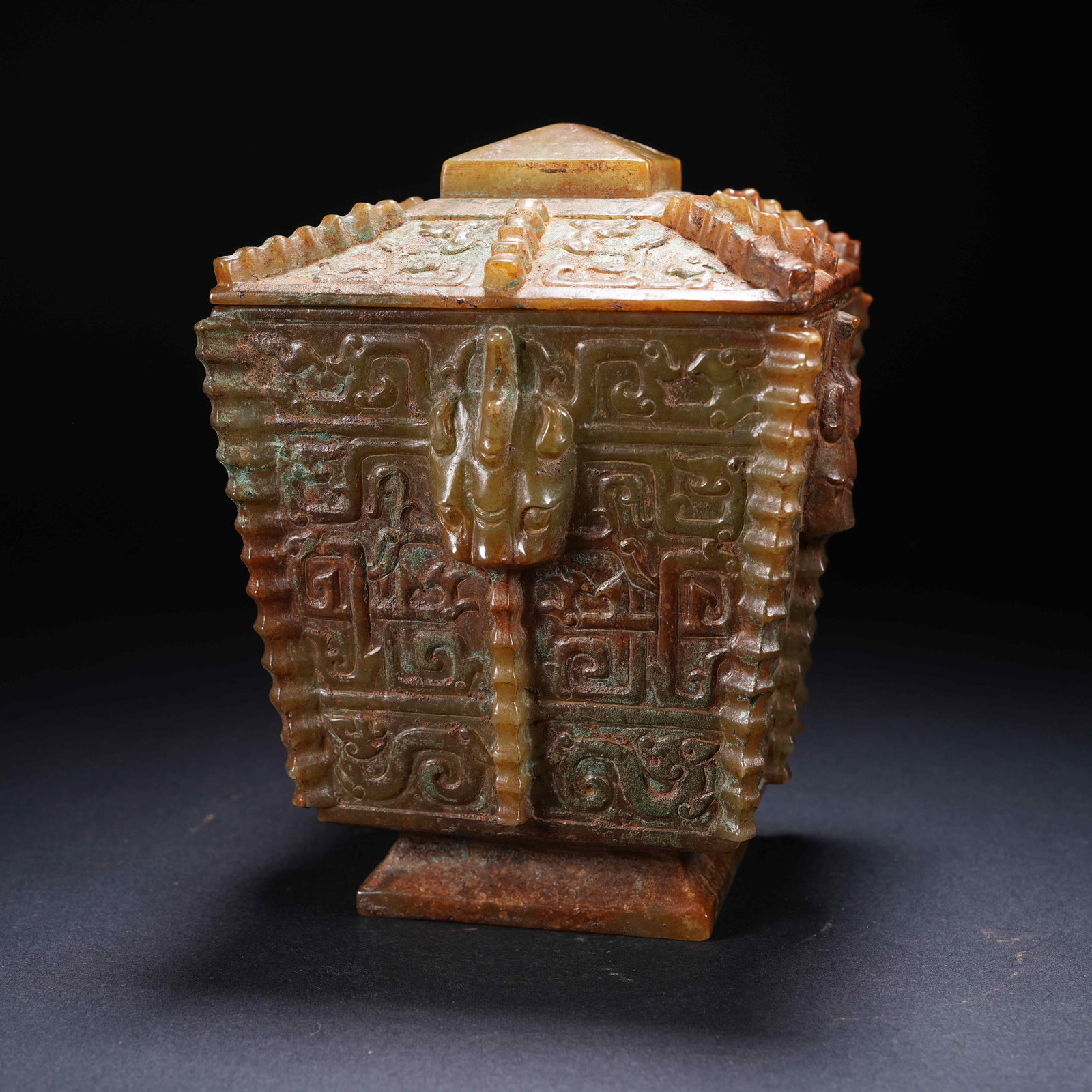 A ARCHAIC JADE SQUARE DING VESSEL WITH BEAST-MASK MOTIFS: Archaic Jade Square Ding Vessel with Beast-Mask Motifs
