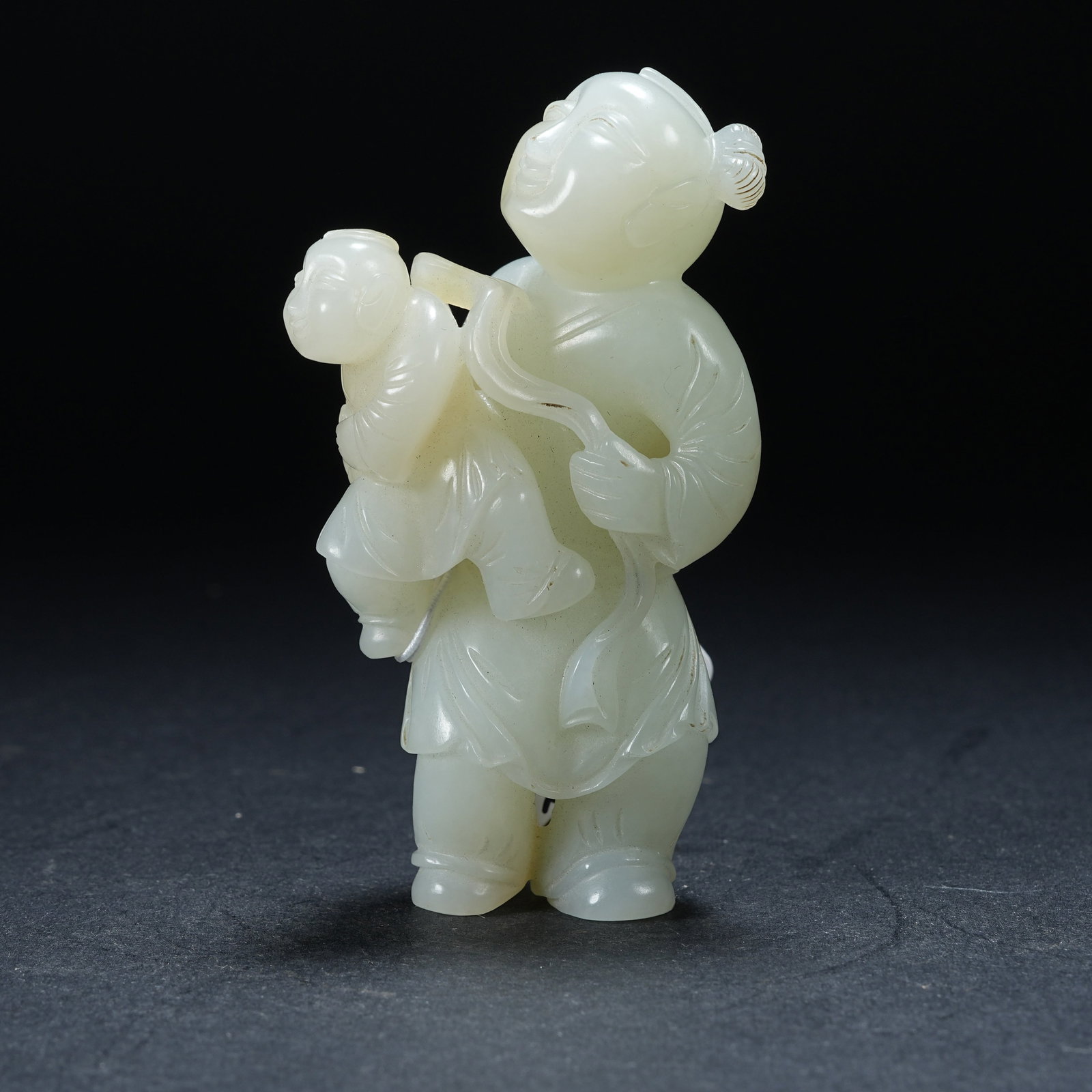 A HETIAN JADE BOY BRINGING BLESSINGS HANDHELD ORNAMENT: Hetian Jade Boy Bringing Blessings Handheld Ornament
