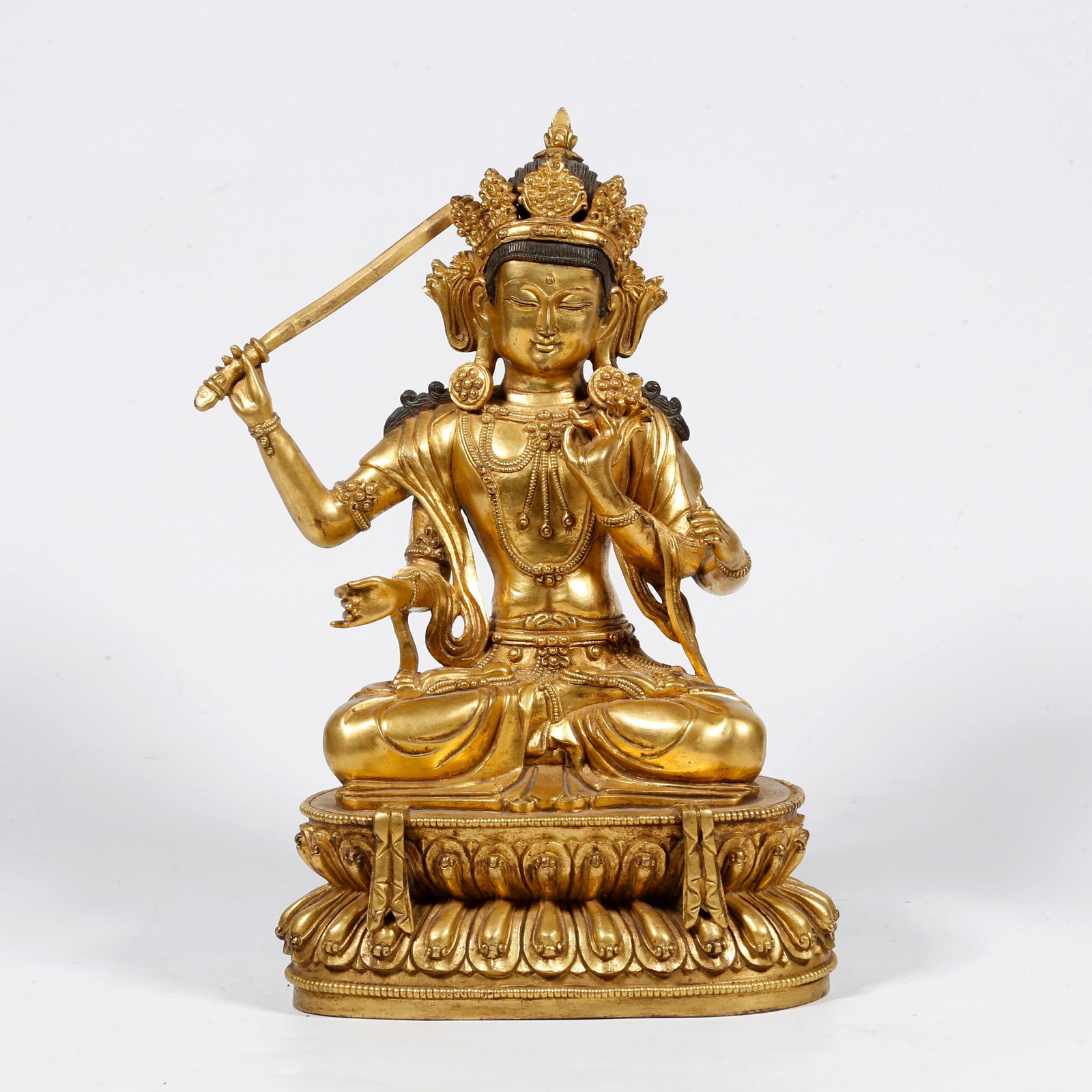 A GILT-BRONZE FOUR-ARMED BUDDHA STATUE: Gilt-bronze Four-armed Buddha statue
