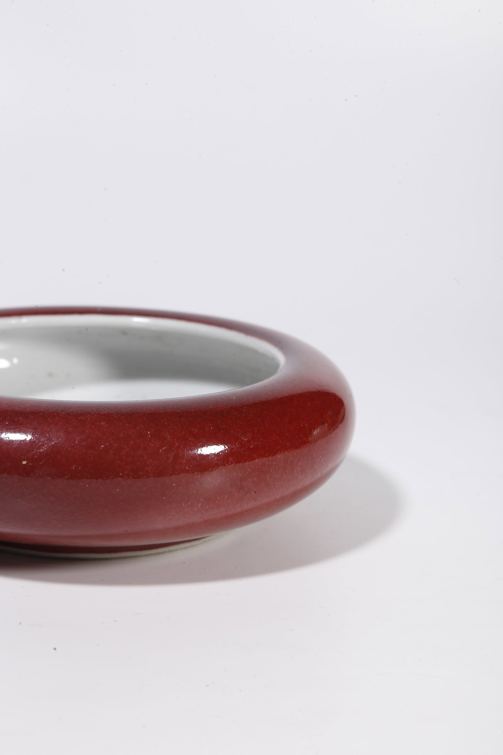 A RED GLAZE WASHER - 6