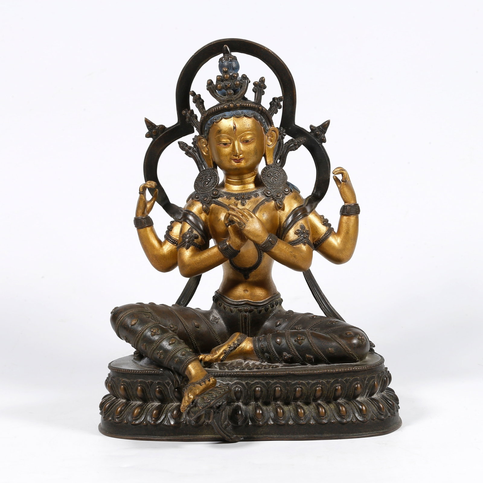 A GILT-BRONZE FOUR-ARMED BUDDHA STATUE (PARTIALLY GILDED) (1 of 9)