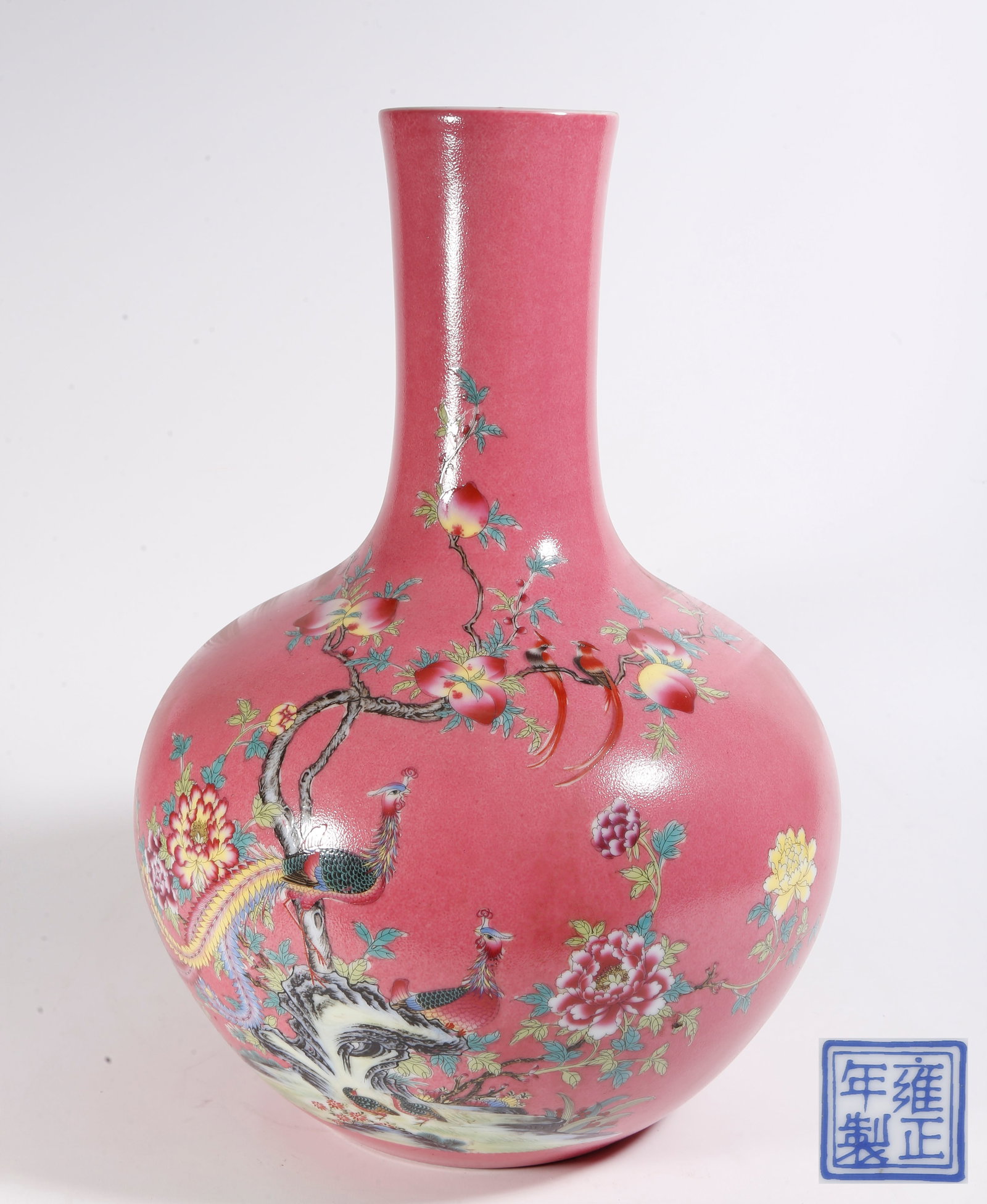 A CRIMSON-GROUND FAMILLE ROSE PEACOCK PATTERN CELESTIAL SPHERE VASE: Crimson-ground Famille Rose Peacock Pattern Celestial Sphere Vase