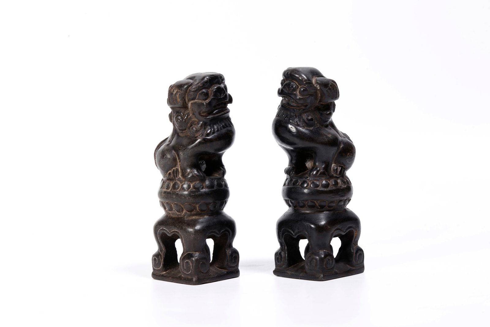 A PAIR OF STONE LION ORNAMENTS: Pair of Stone Lion Ornaments
