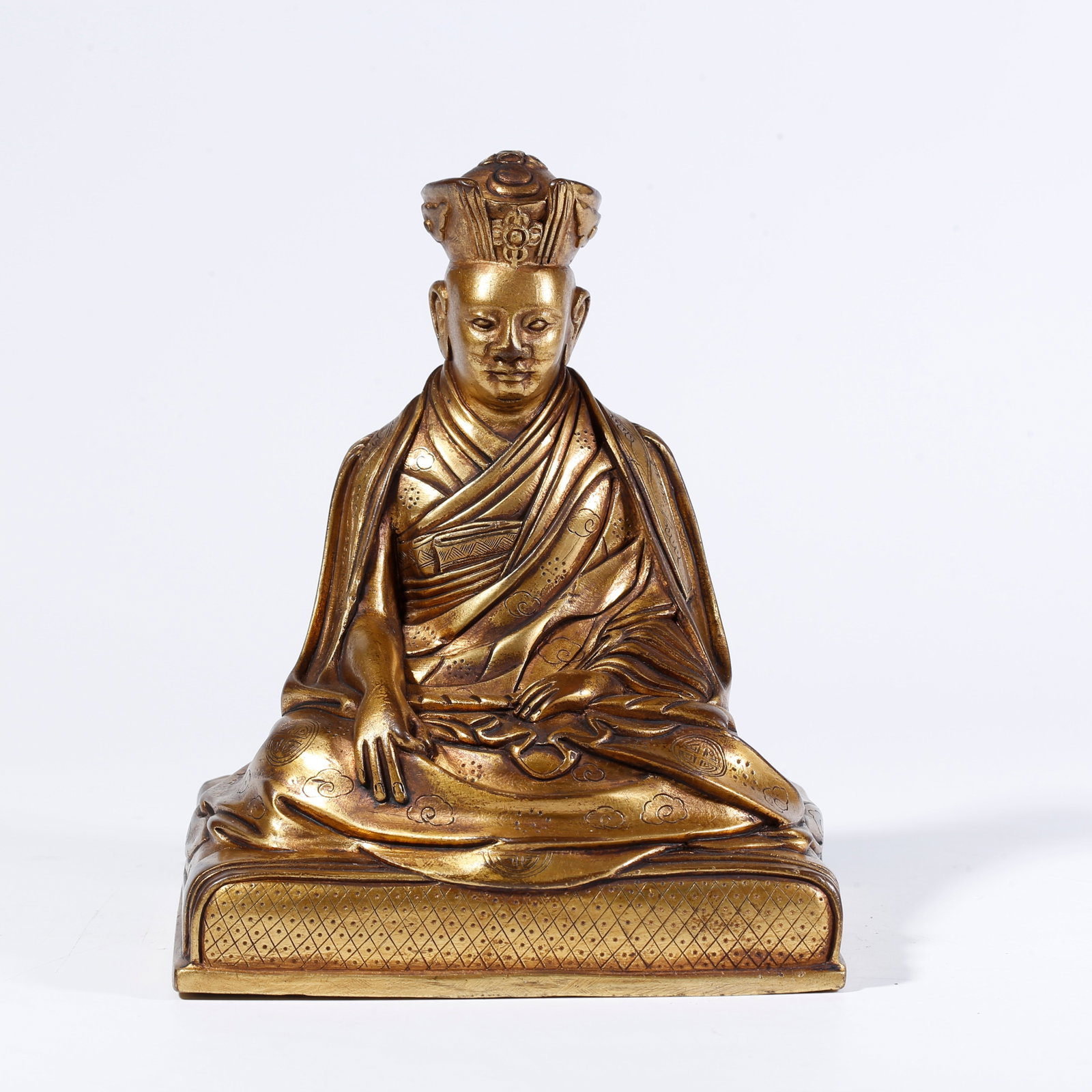 A GILT-BRONZE LAMA FIGURE (1 of 9)