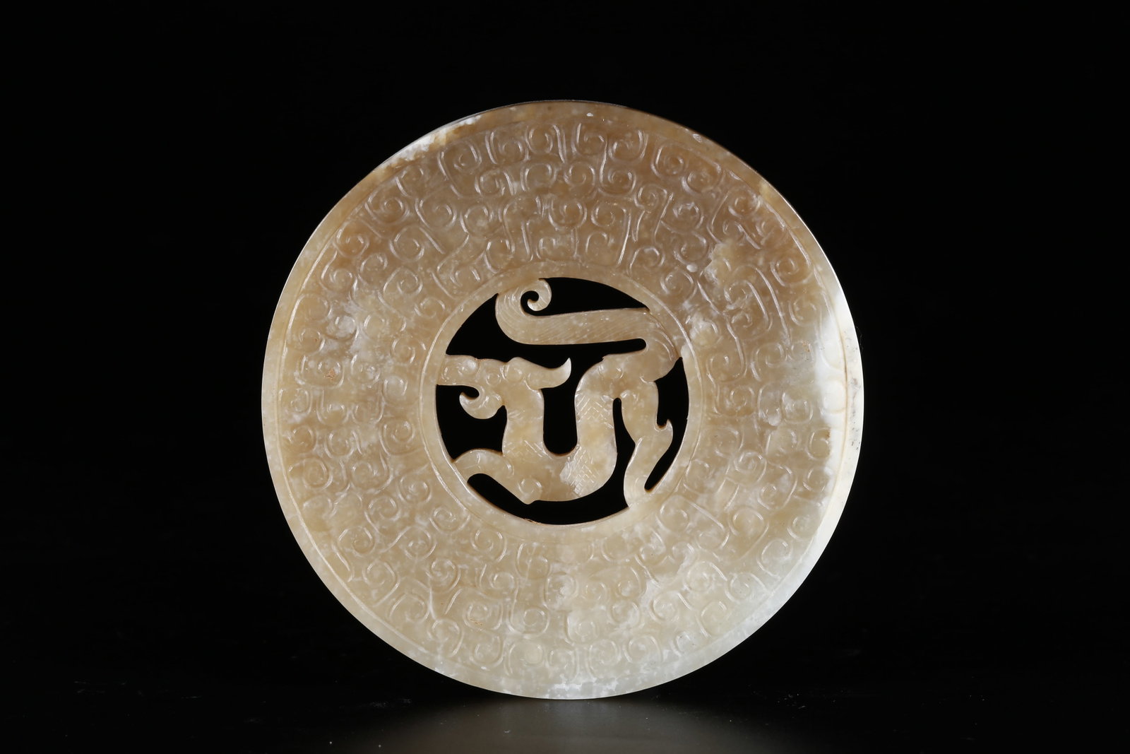 A ARCHAIC JADE BI DISC WITH DRAGON PATTERNS (1 of 9)