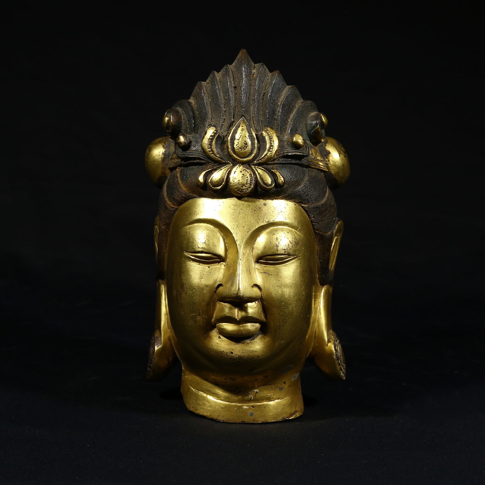 A GILDED BRONZE HEAD OF A BODHISATTVA: Gilded bronze head of a Bodhisattva