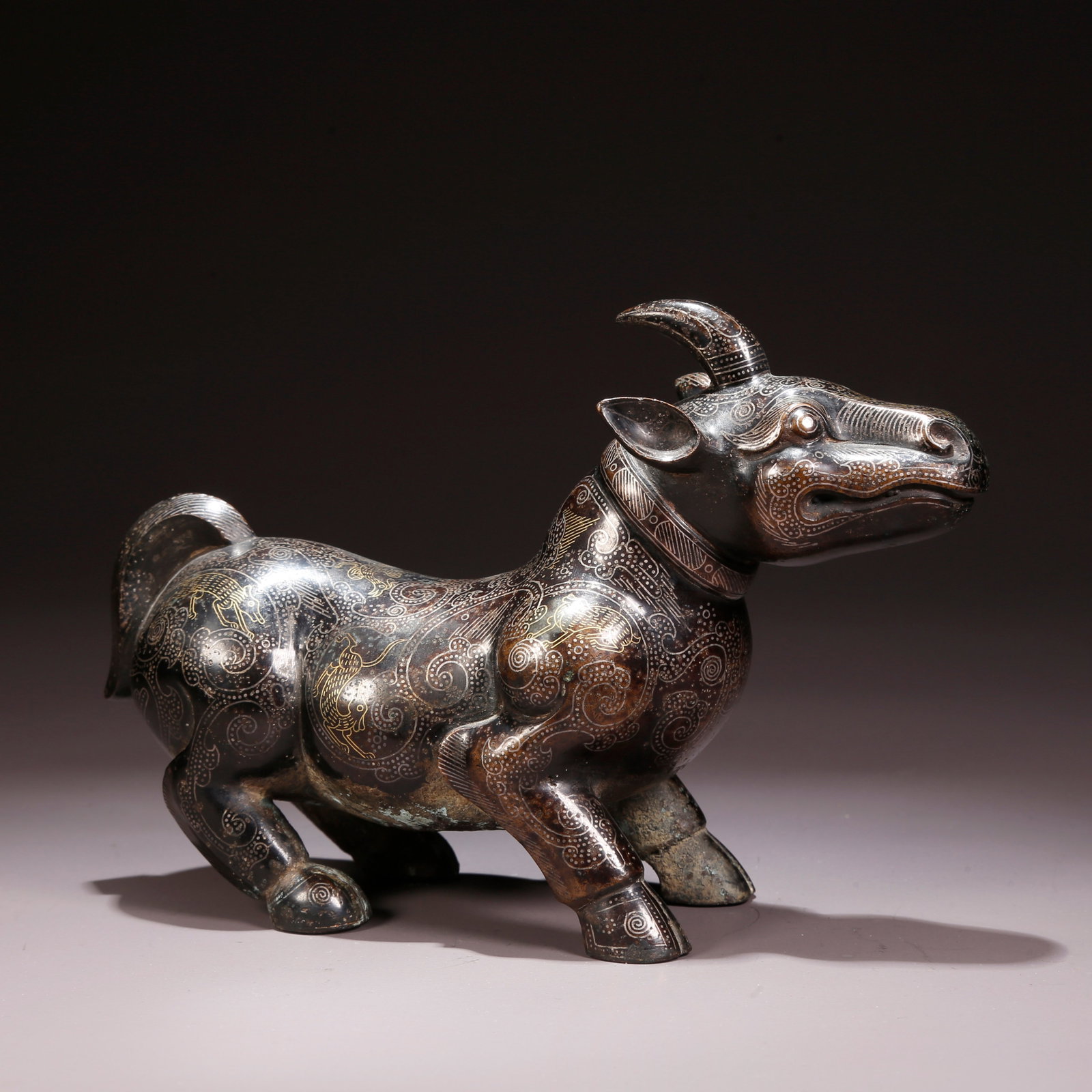 A GILT AND SILVER INLAID BRONZE BEAST FIGURINE (1 of 10)