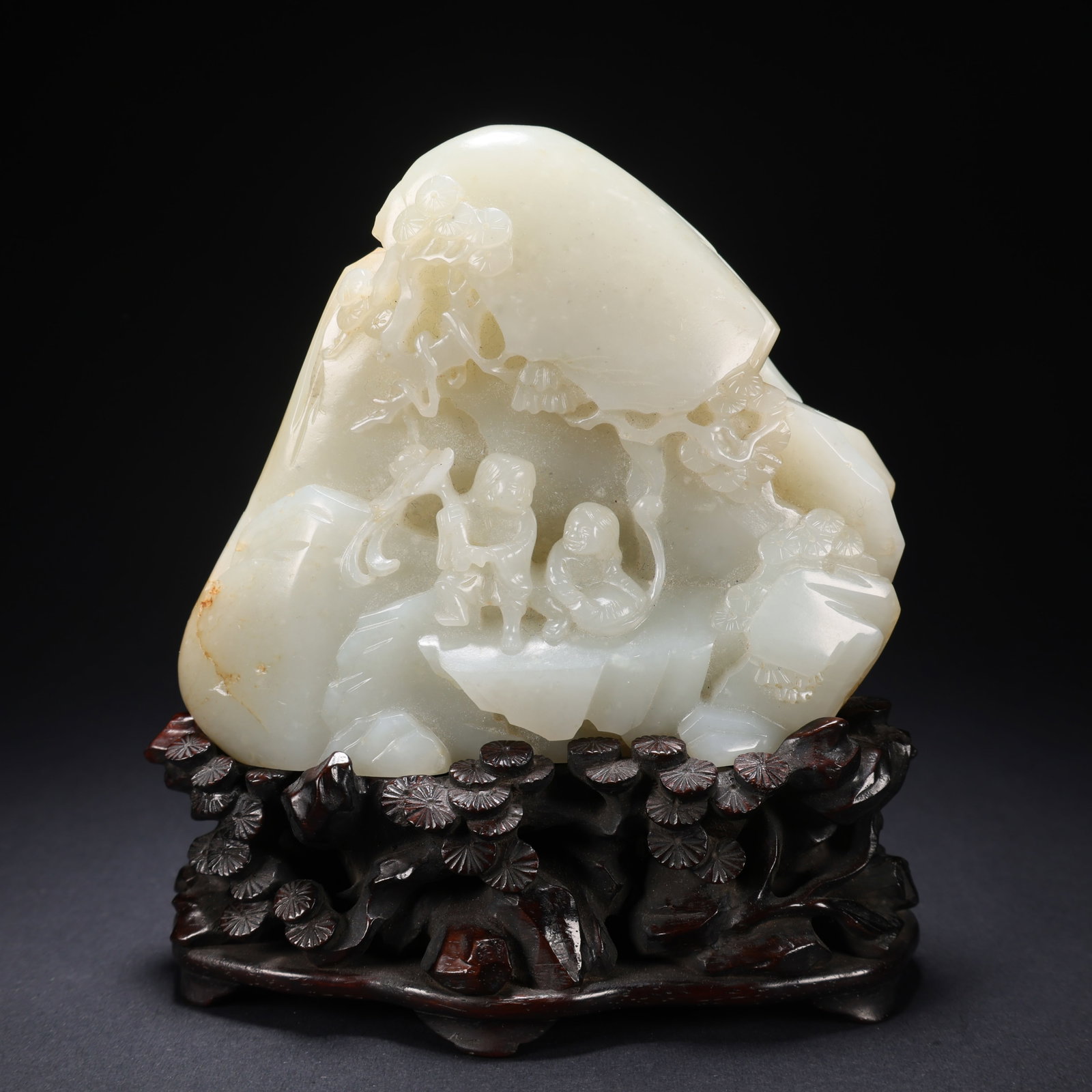 A HETIAN JADE "JOY AT THE TIP OF THE BROW" FIGURINE ON WOODEN STAND: Hetian Jade "Joy at the Tip of the Brow" Figurine on Wooden Stand