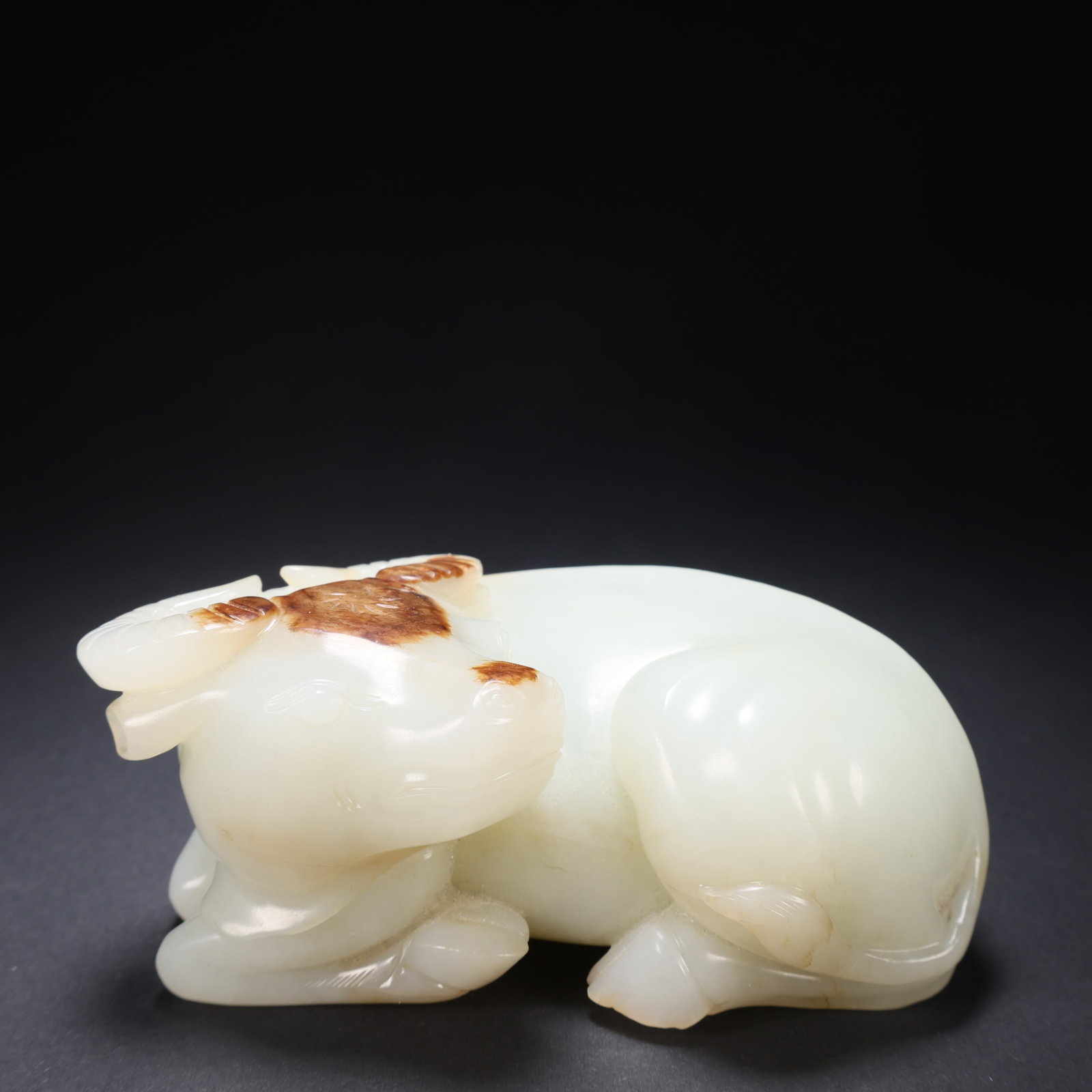 A HETIAN JADE RECLINING OX: Hetian Jade Reclining Ox