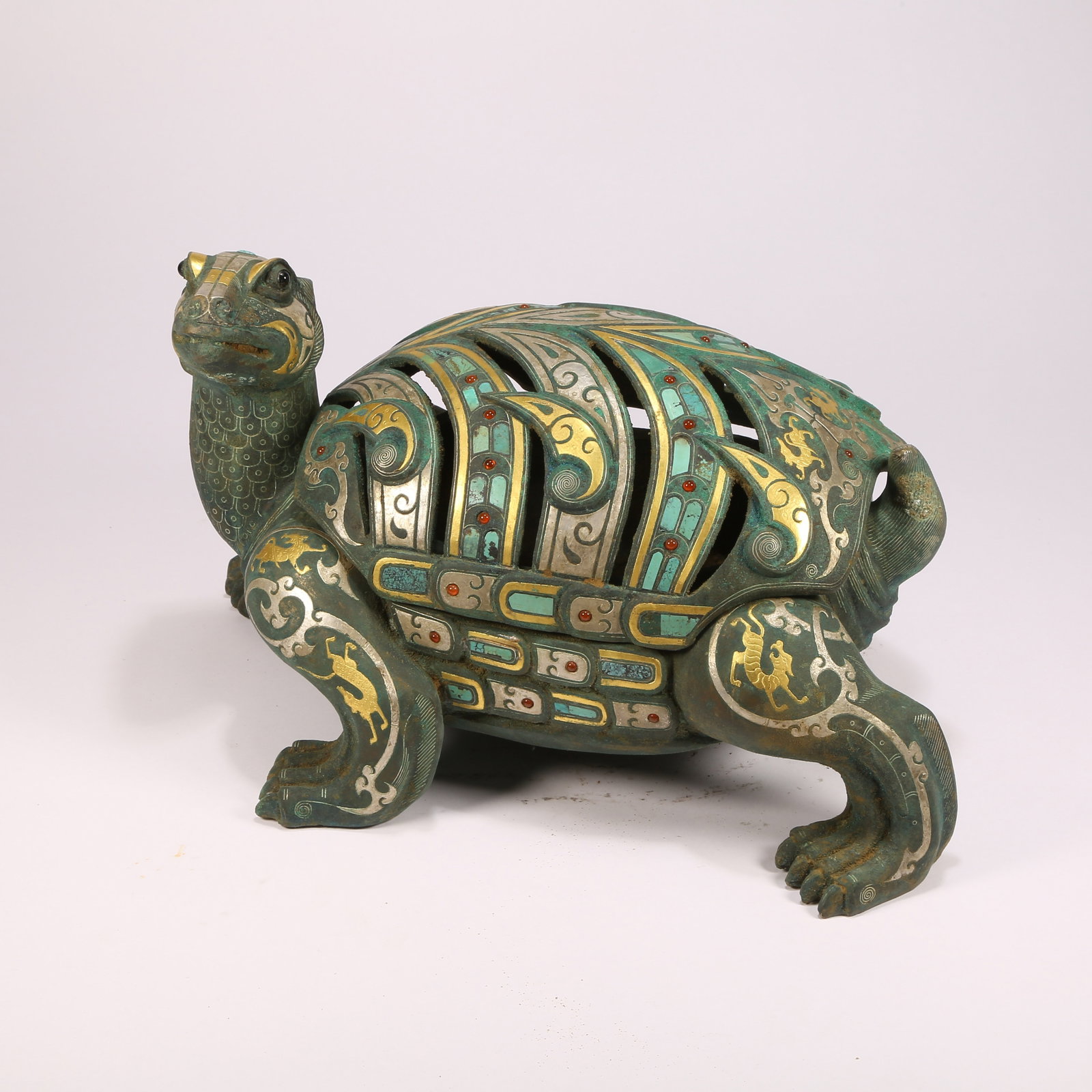A BRONZE INCENSE BURNER IN THE FORM OF A SACRED TURTLE WITH GILT-INLAID GOLD, SILVER, AND GEMSTONES: Bronze incense burner in the form of a sacred turtle with gilt-inlaid gold, silver, and gemstones