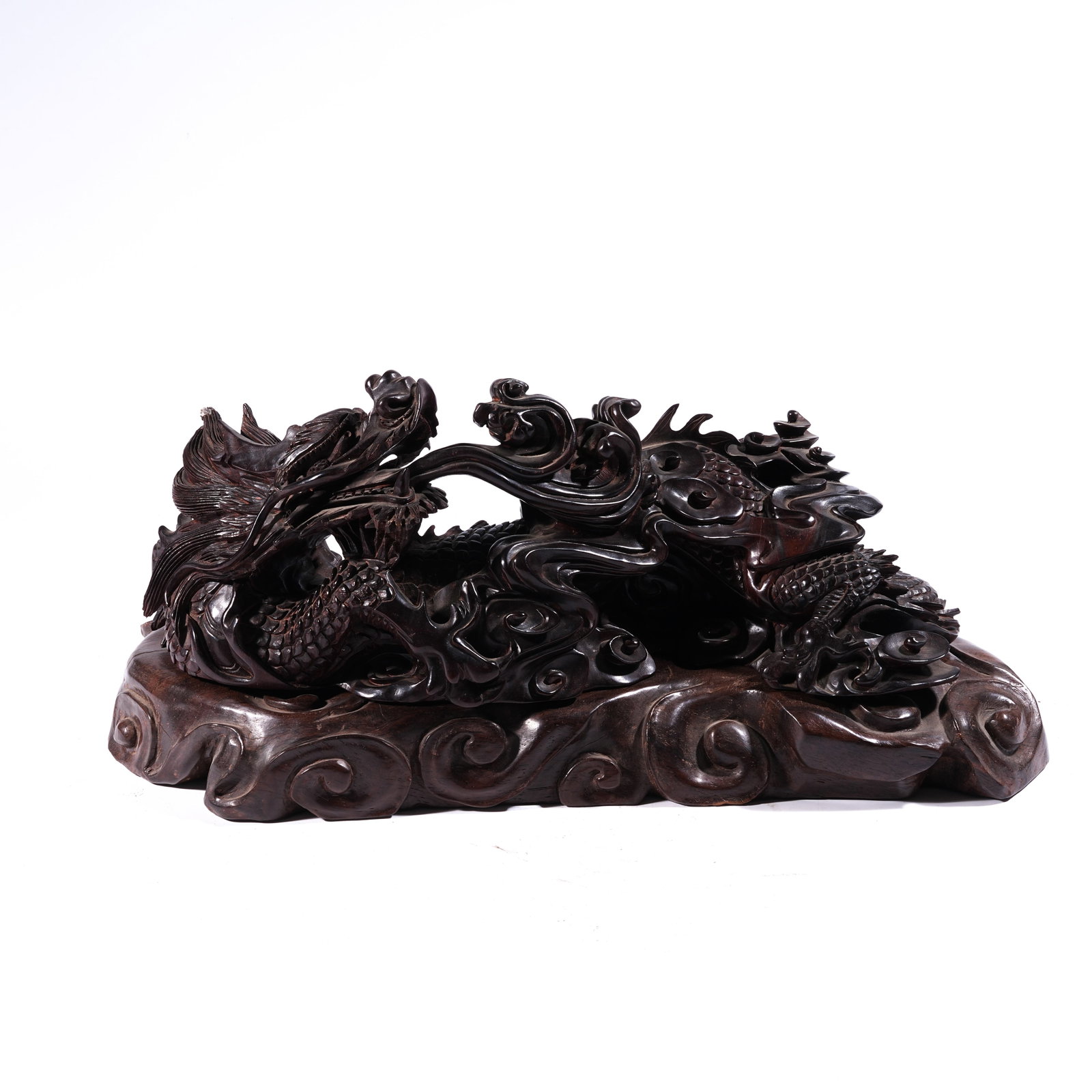 A MOUNTAIN-FORM ORNAMENT WITH CLOUD-AND-DRAGON MOTIF IN ZITAN WOOD: Mountain-Form Ornament with Cloud-and-Dragon Motif in Zitan Wood