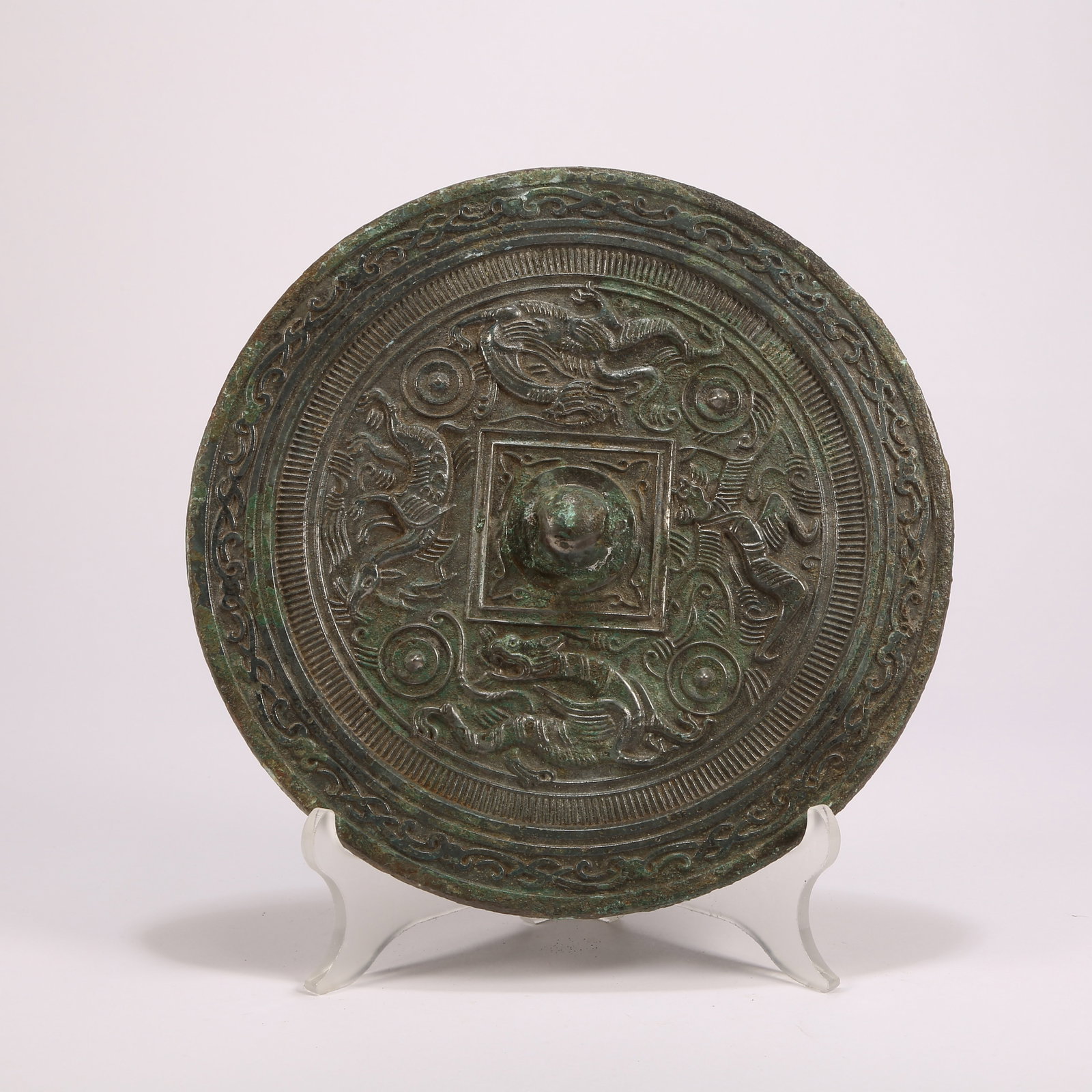 A BRONZE MIRROR WITH PLAYFUL-BEAST MOTIF (1 of 10)