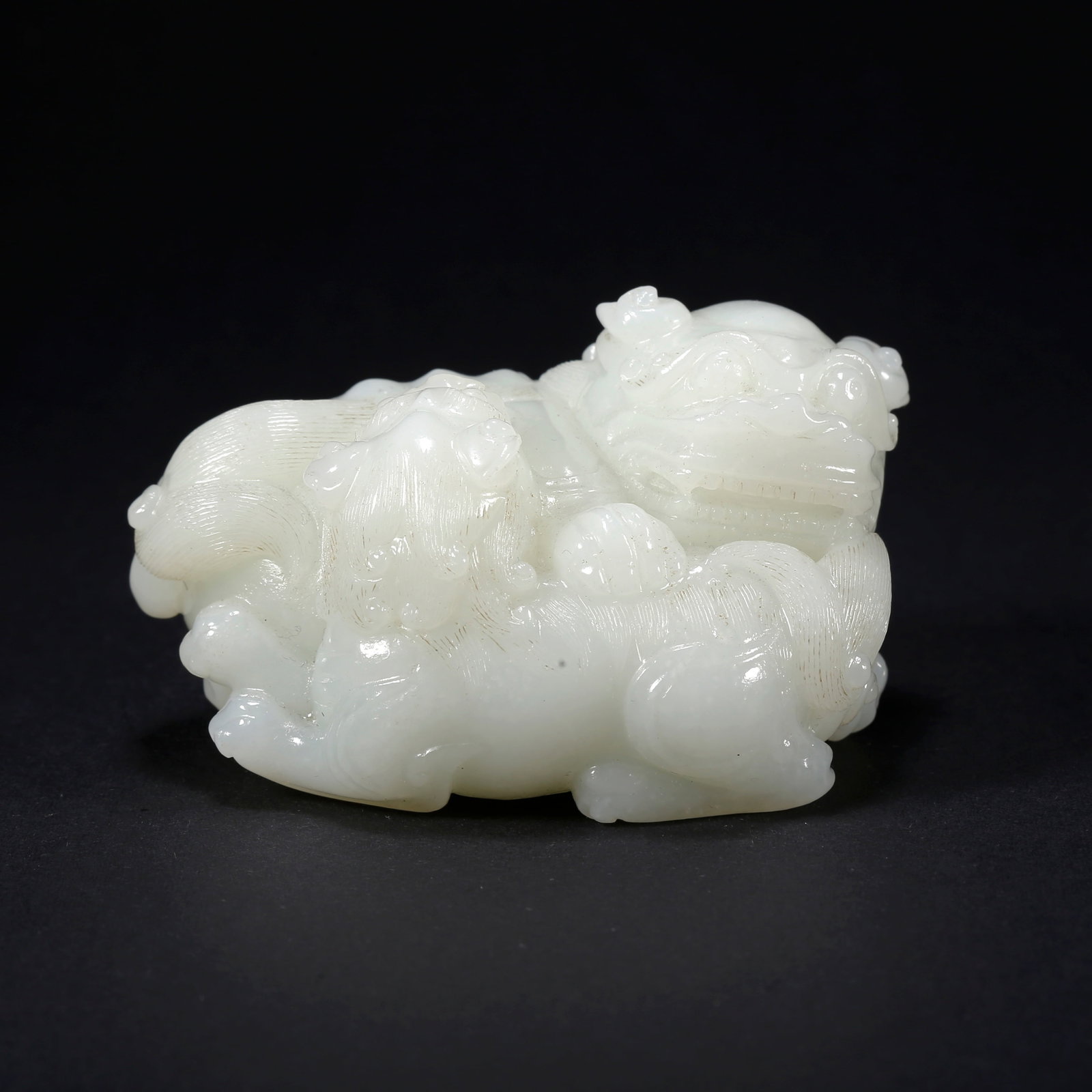 A HETIAN JADE ADULT AND CUB LION-SHAPED FIGURINE: Hetian Jade Adult and Cub Lion-Shaped Figurine