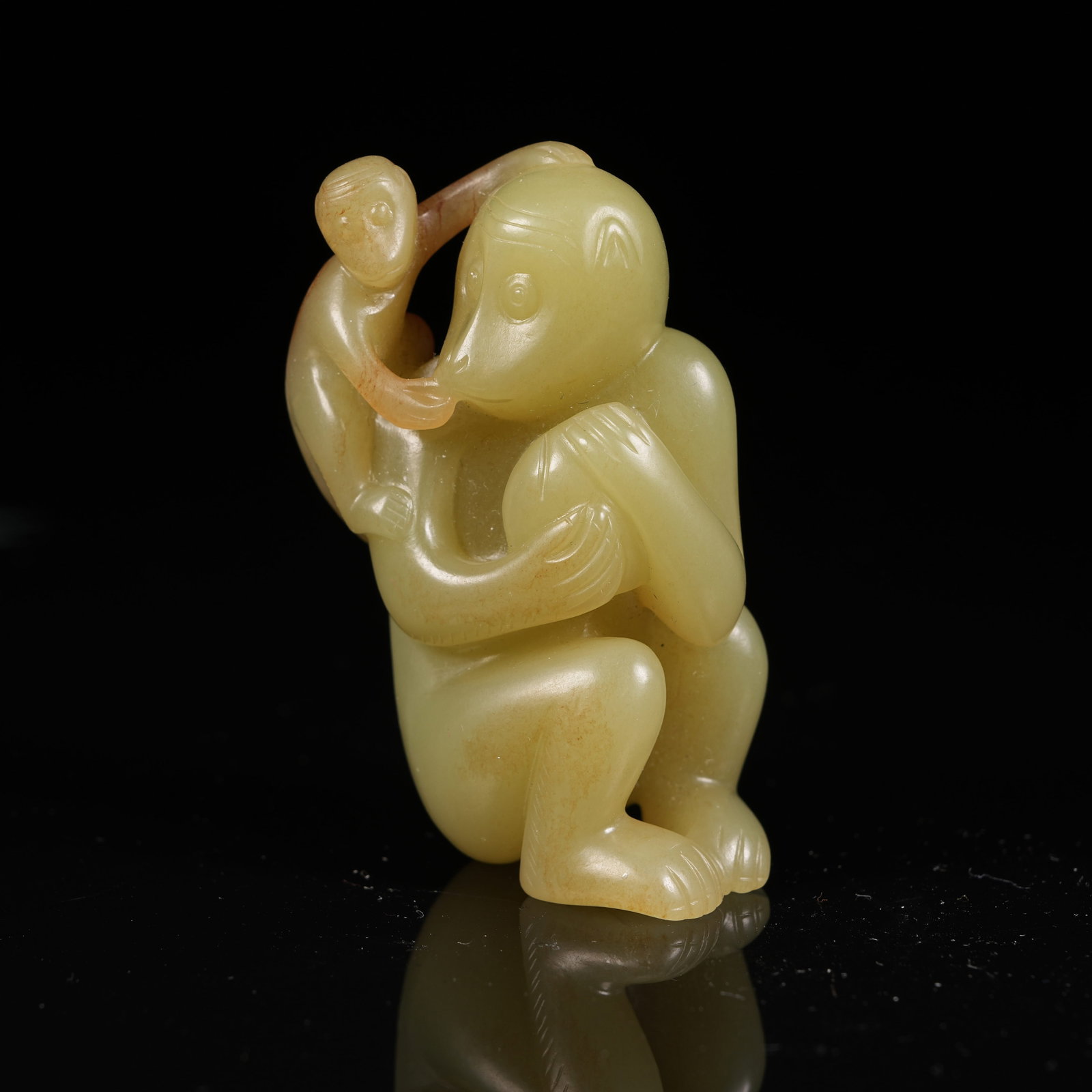 A HETIAN YELLOW JADE MONKEY PRESENTING LONGEVITY ORNAMENT: Hetian Yellow Jade Monkey Presenting Longevity Ornament