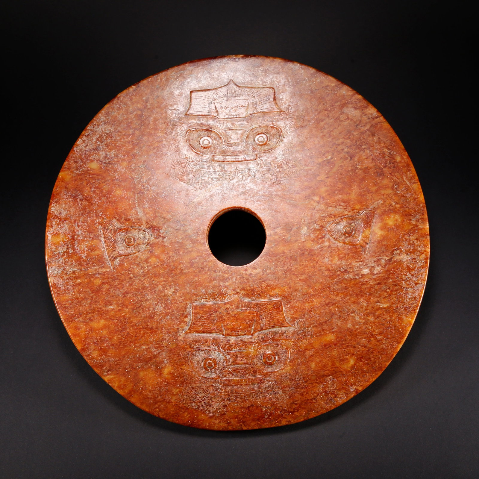 A HETIAN JADE BI DISC WITH BEAST FACE MOTIF: Hetian Jade Bi Disc with Beast Face Motif