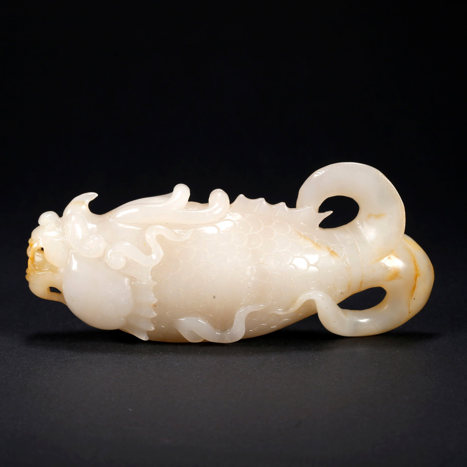 A HETIAN JADE FISH-TO-DRAGON TRANSFORMATION FIGURINE (1 of 10)