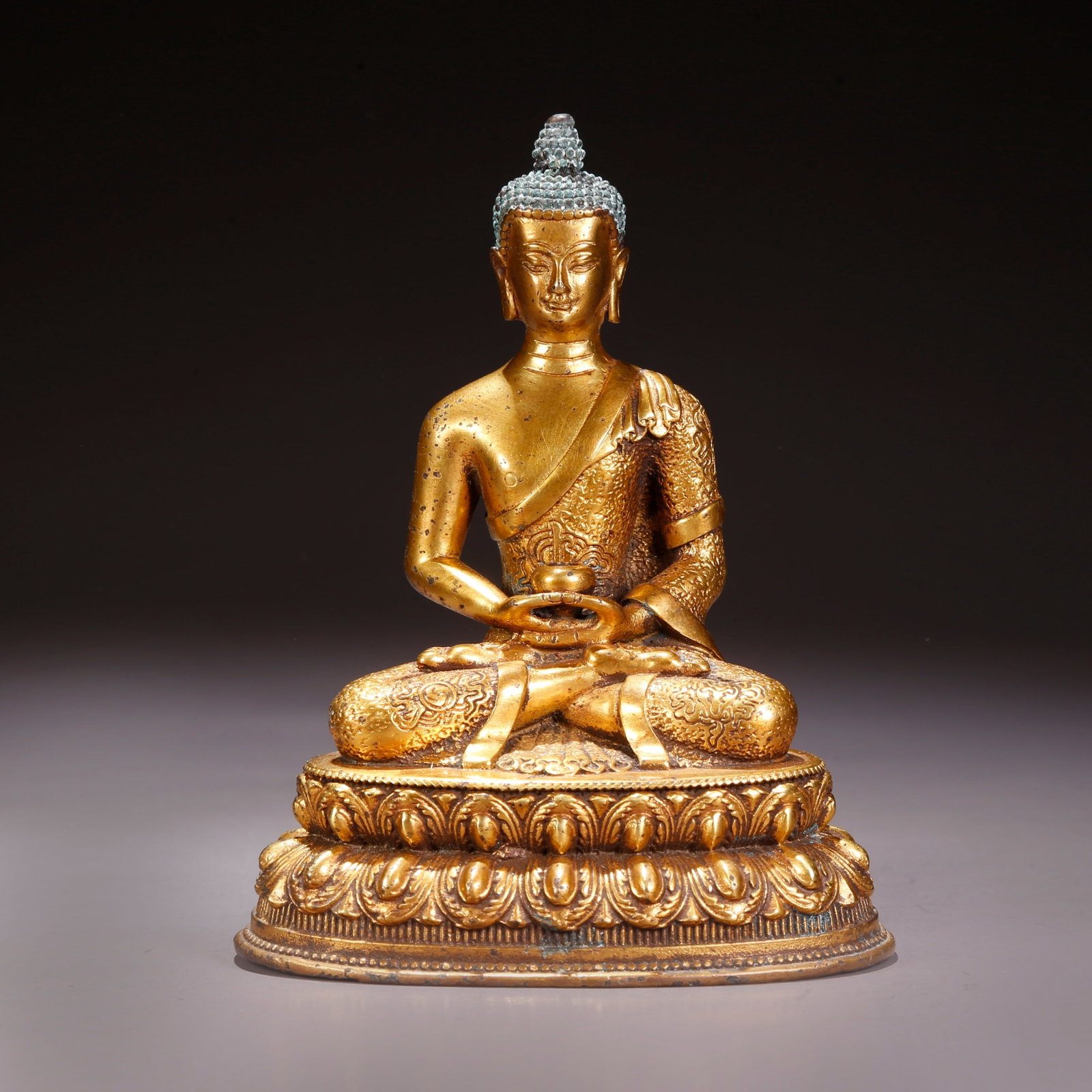 A GILT-BRONZE AMITAYUS (INFINITE-LIFE BUDDHA) FIGURE: Gilt-Bronze Amitayus (Infinite-Life Buddha) Figure