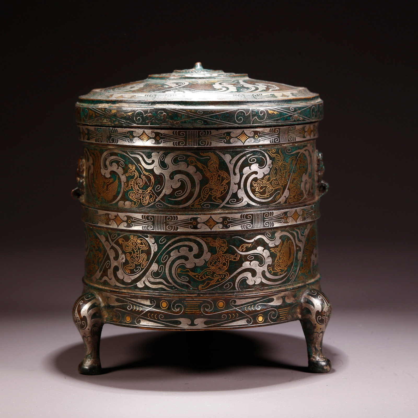 A GILT AND SILVER INLAID BRONZE TRIPOD COVERED INCENSE BURNER: Gilt and Silver Inlaid Bronze Tripod Covered Incense Burner