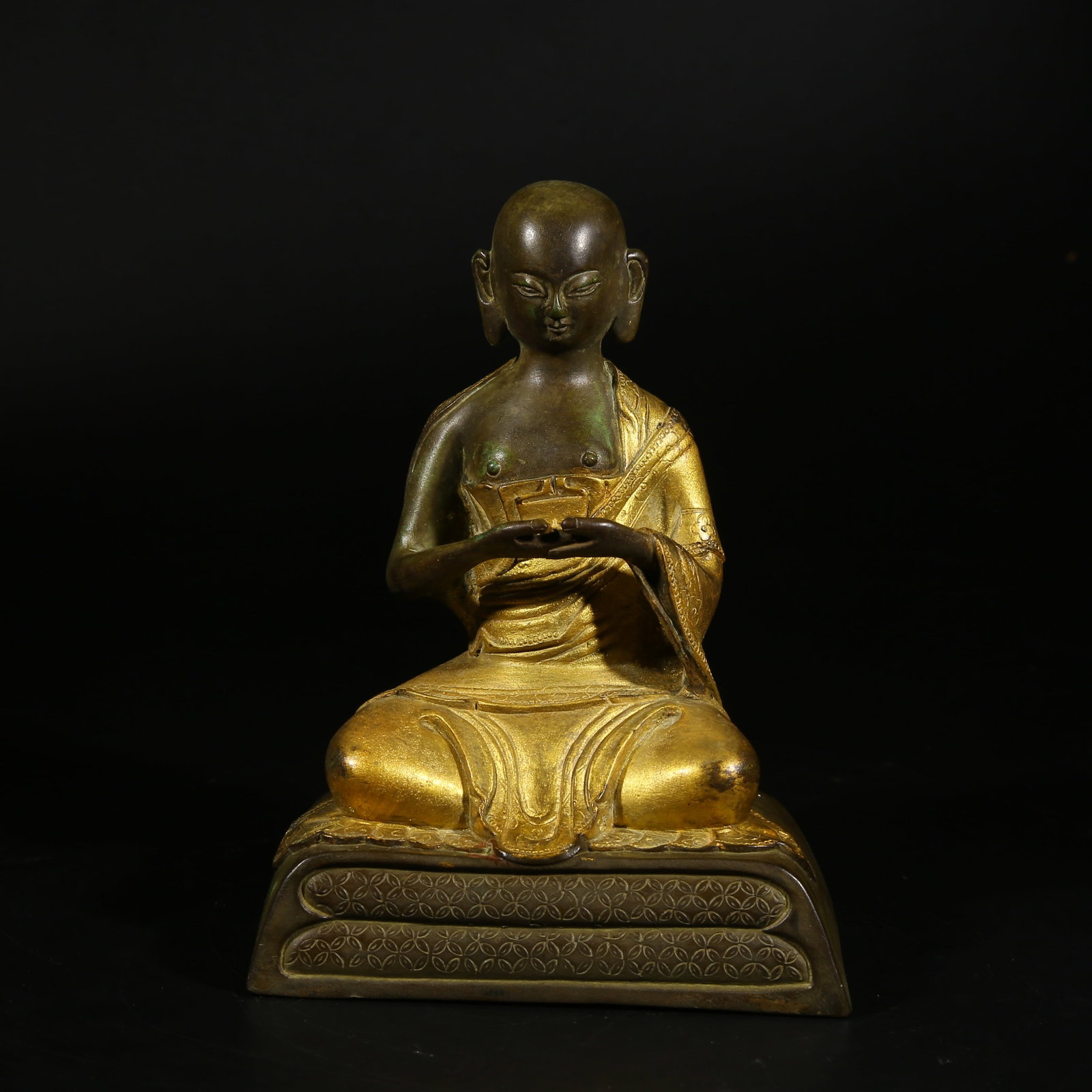 A PARTIALLY GILDED BRONZE STATUE OF A GURU (1 of 8)