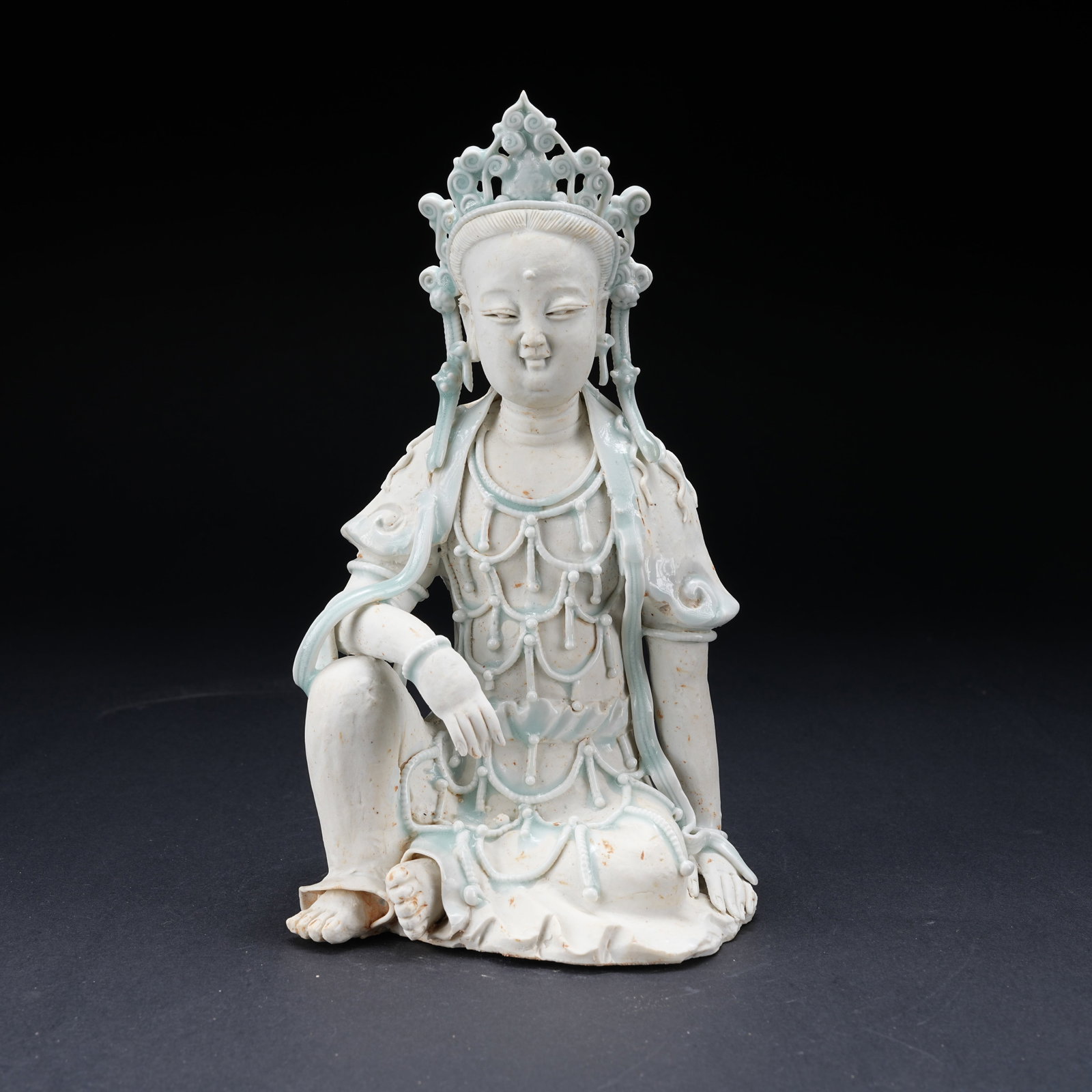 A WHITE PORCELAIN SKY-BLUE GLAZED FREE-FORM GUANYIN SCULPTURE: White Porcelain Sky-Blue Glazed Free-Form Guanyin Sculpture