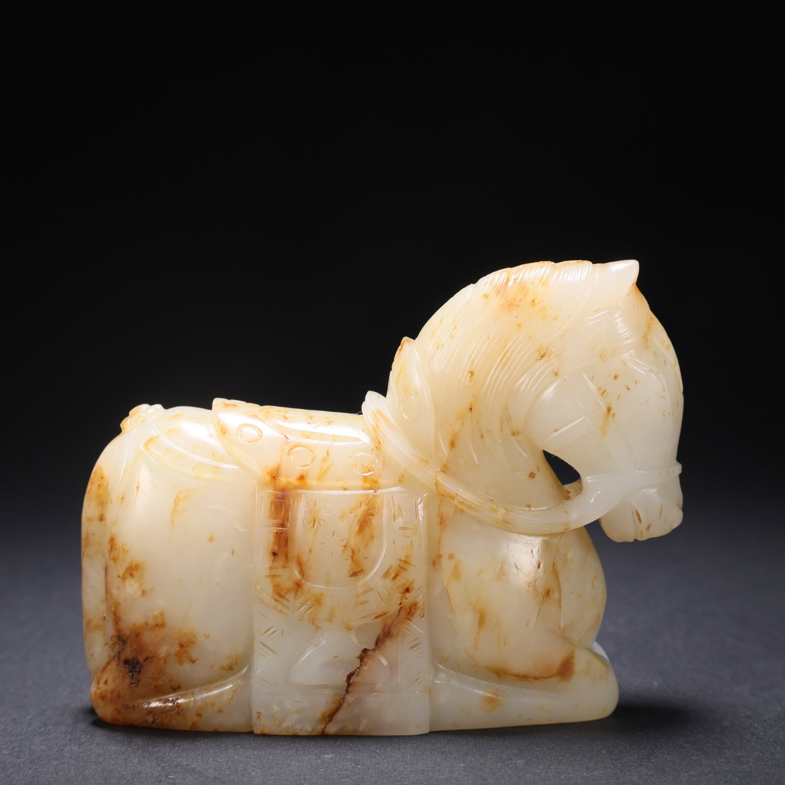 A HETIAN JADE RECLINING HORSE: Hetian Jade Reclining Horse