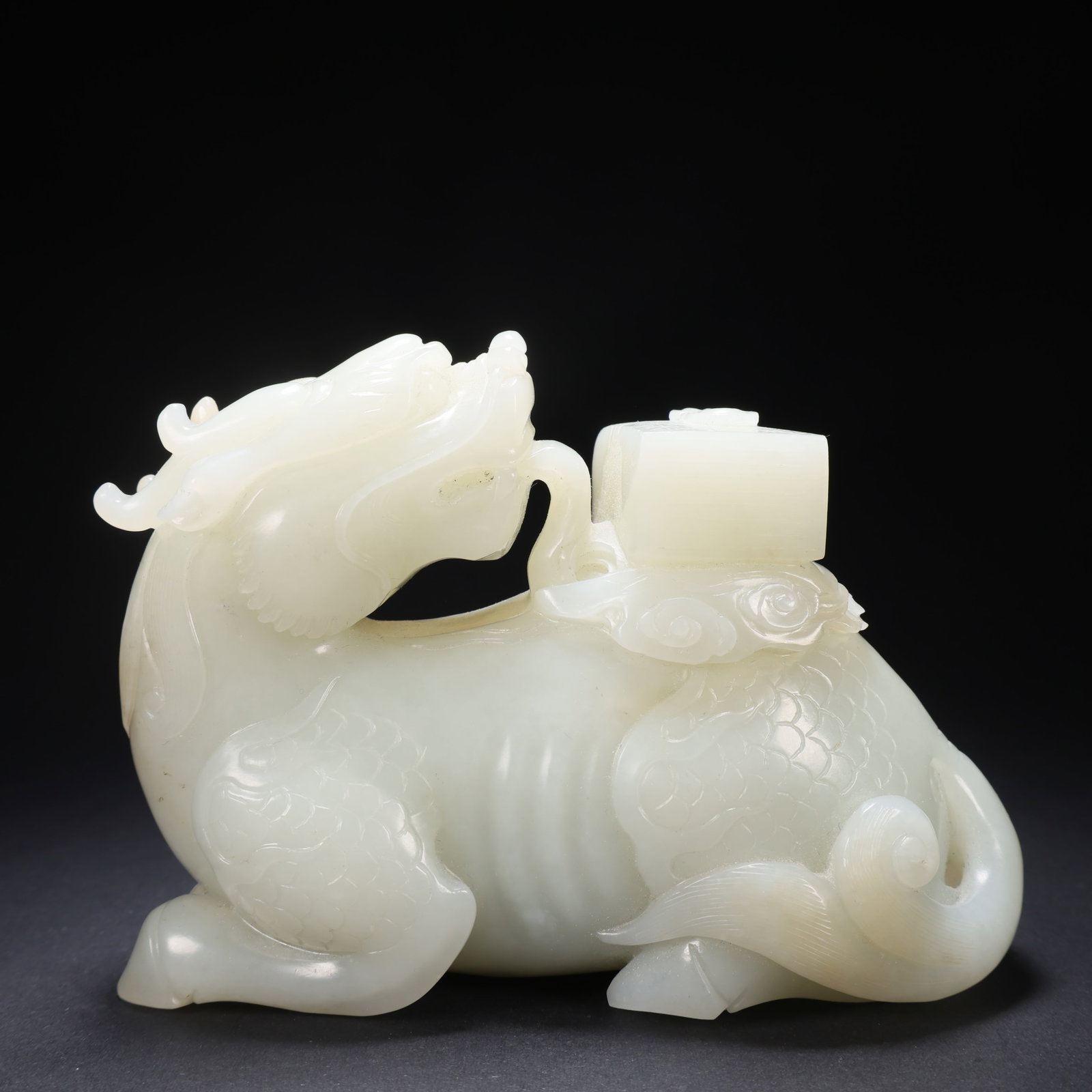A HETIAN JADE QILIN SUPPORTING A BOOK: Hetian Jade Qilin Supporting a Book