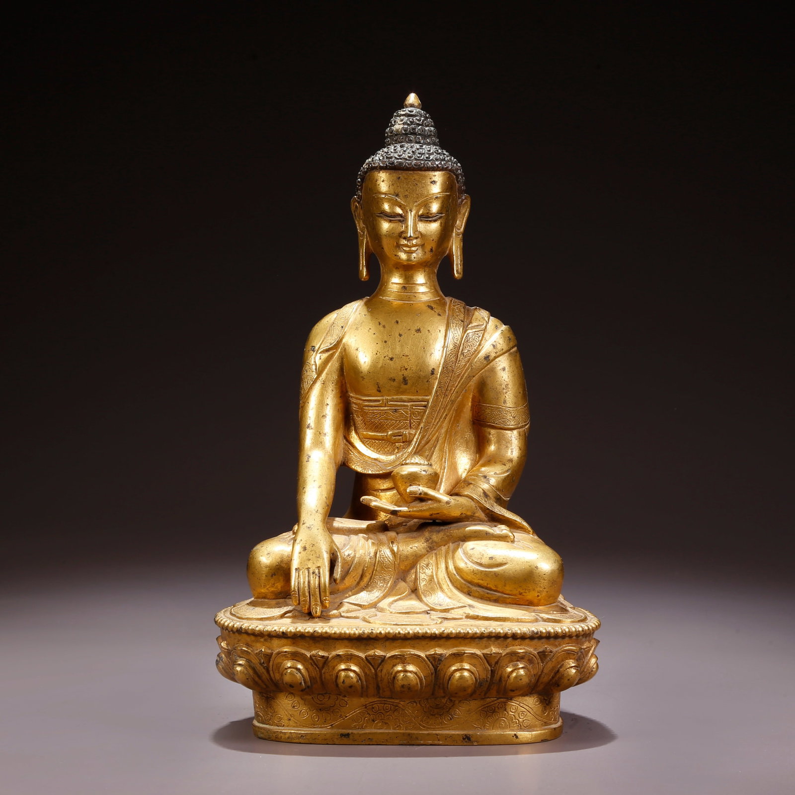 A GILT-BRONZE MEDICINE BUDDHA FIGURE: Gilt-Bronze Medicine Buddha Figure