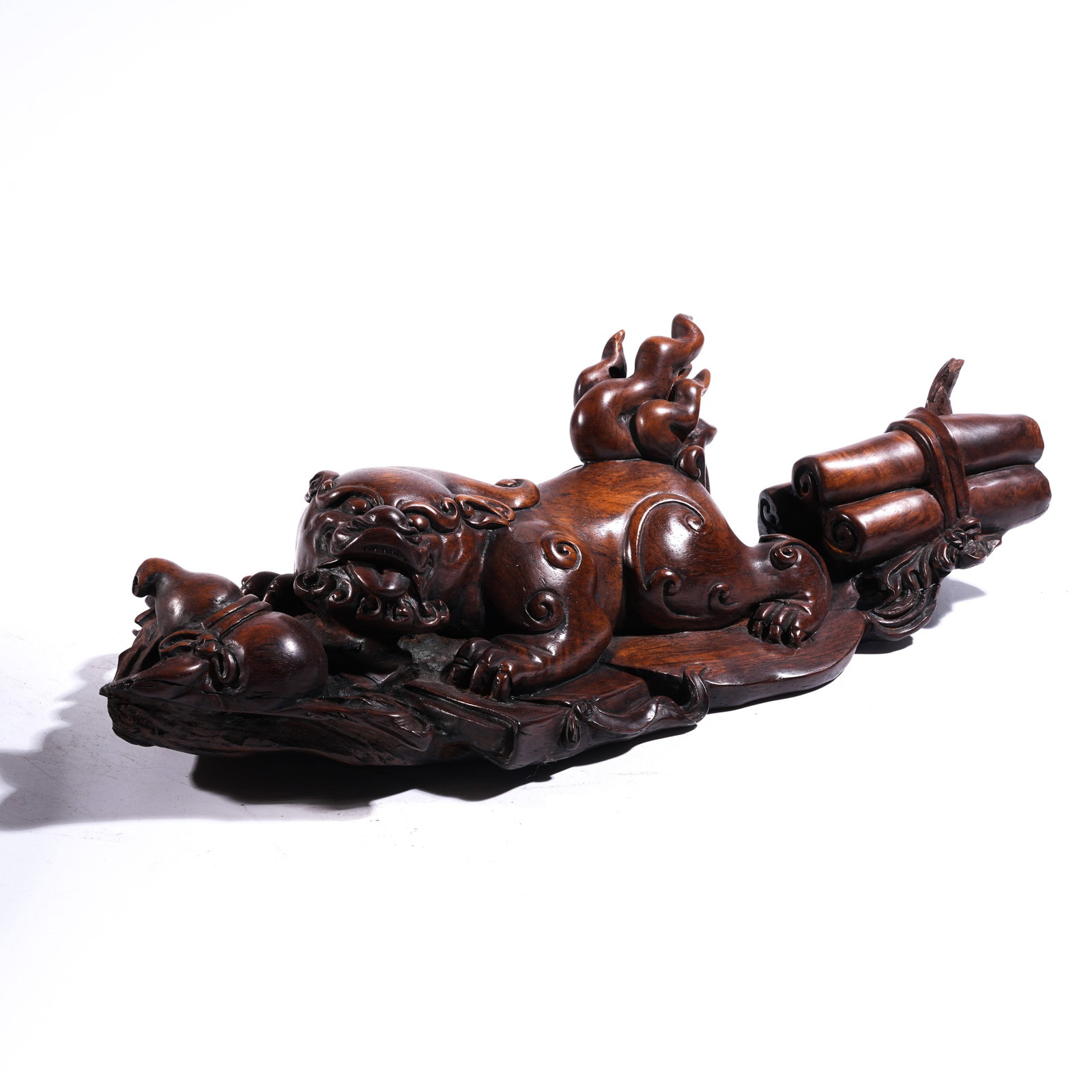 A AUSPICIOUS BEAST ORNAMENT IN HUANGHUALI WOOD: Auspicious Beast Ornament in Huanghuali Wood