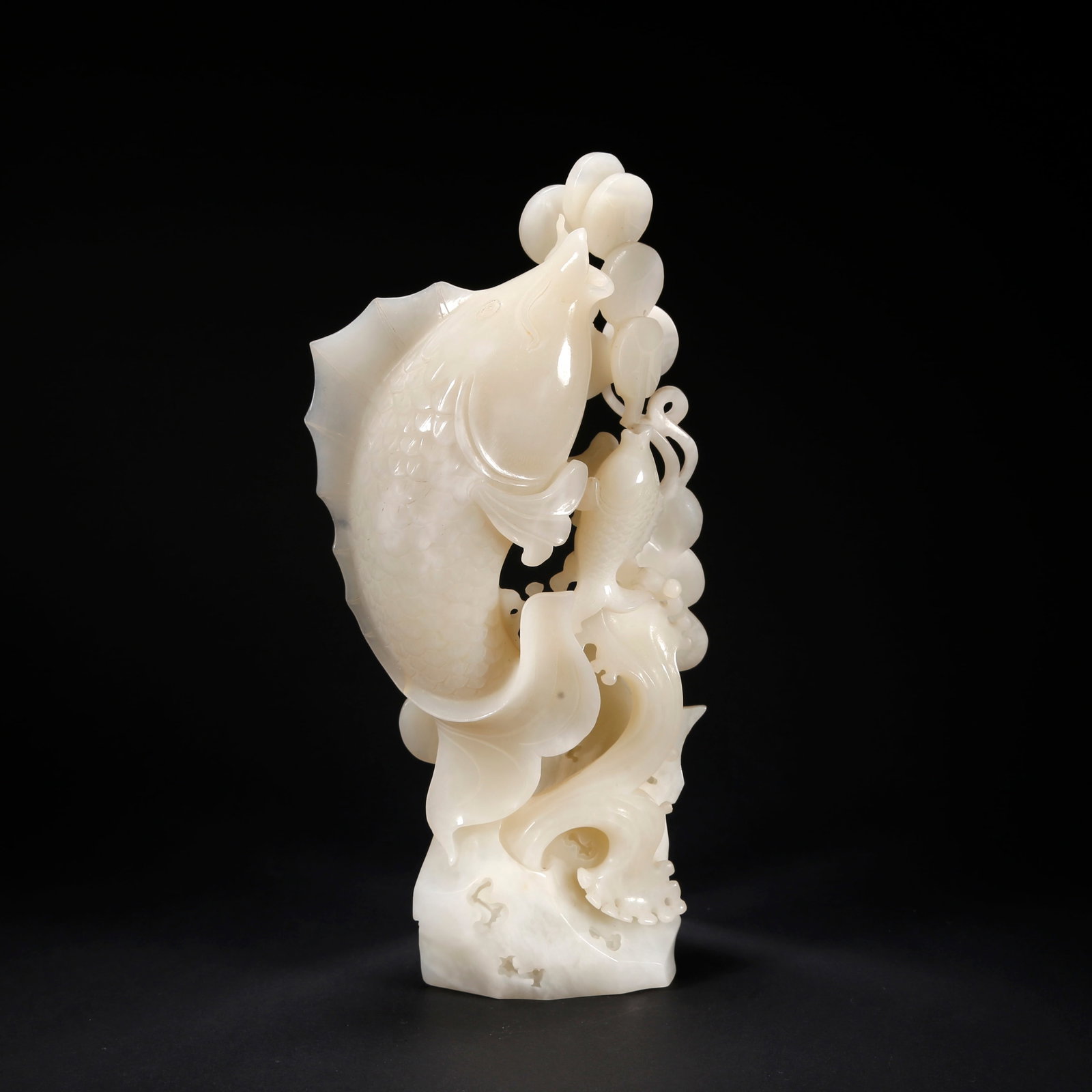 A HETIAN JADE FIGURINE OF "ABUNDANT YEARLY SURPLUS" (1 of 9)