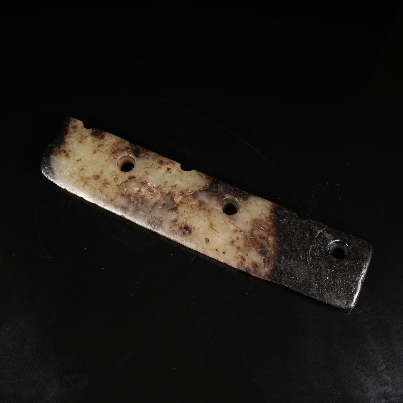 A ANCIENT JADE THREE-HOLE BLADE: Ancient Jade Three-hole Blade