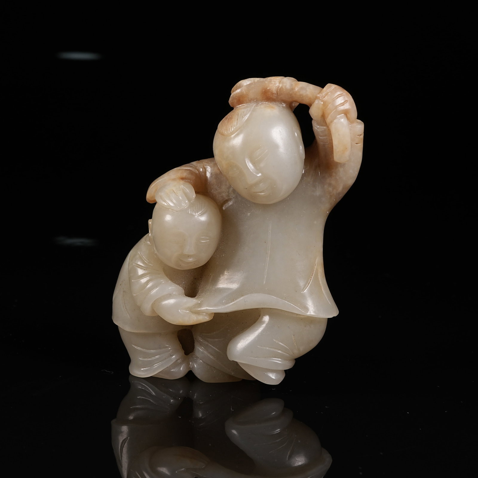 A HETIAN JADE ORNAMENT OF BOY HOLDING LOTUS: Hetian Jade Ornament of Boy Holding Lotus