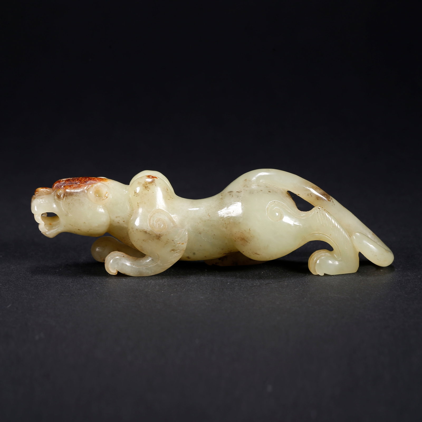 A HETIAN JADE TIGER-SHAPED FIGURINE: Hetian Jade Tiger-Shaped Figurine