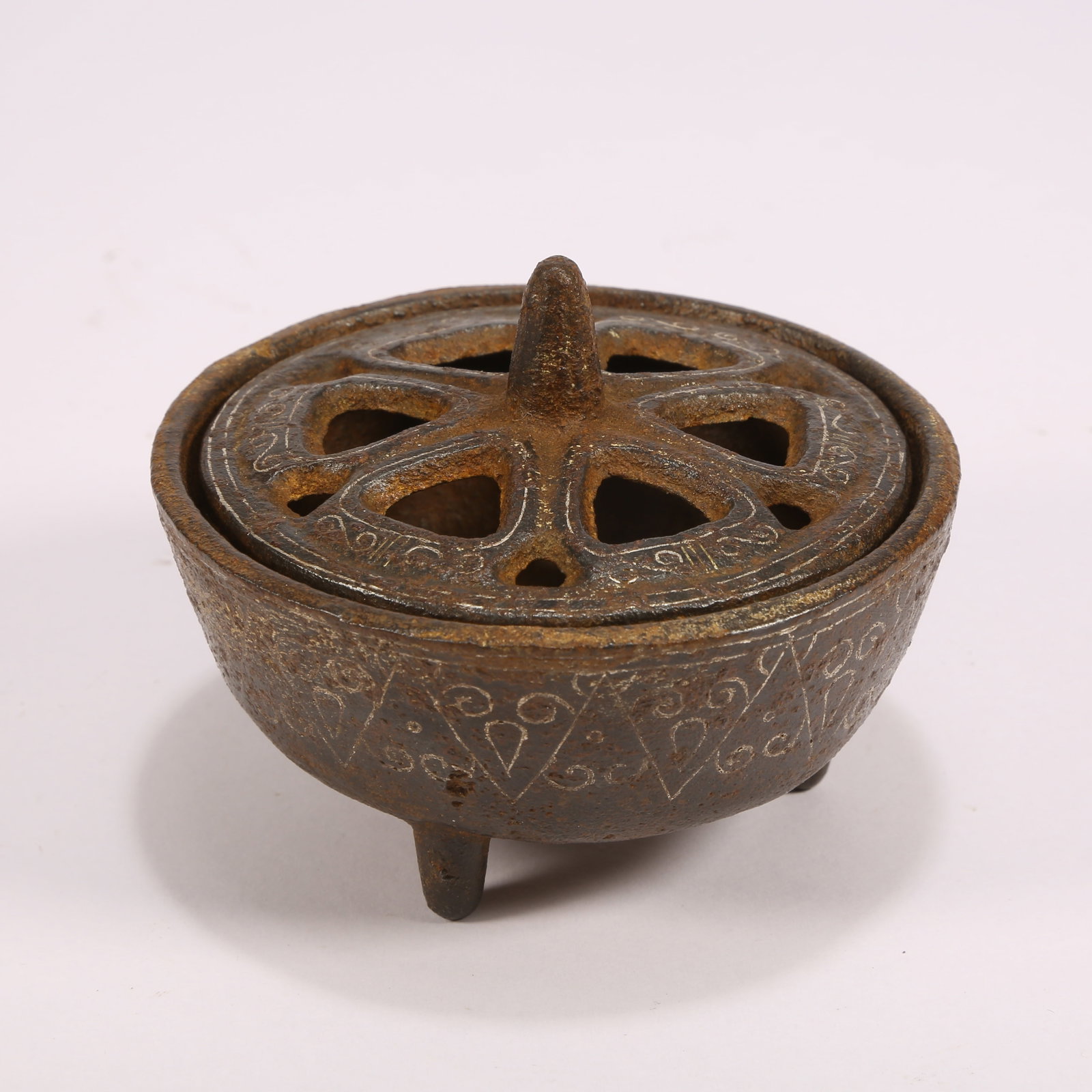 A BRONZE TRIPOD INCENSE BURNER WITH SILVER INLAY: Bronze tripod incense burner with silver inlay