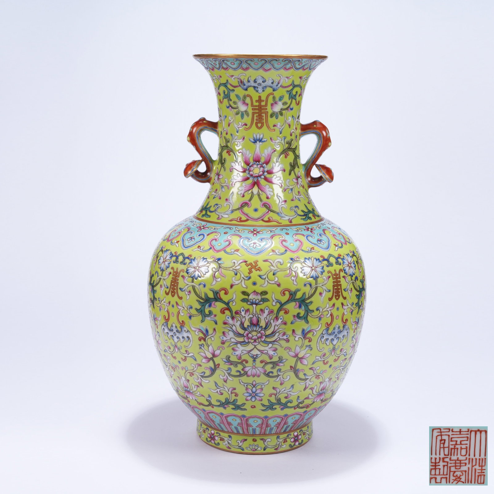 A FAMILLE ROSE ZUN VASE WITH INTERLOCKING FLORAL PATTERN AND RUYI EARS: Famille Rose Zun Vase with Interlocking Floral Pattern and Ruyi Ears