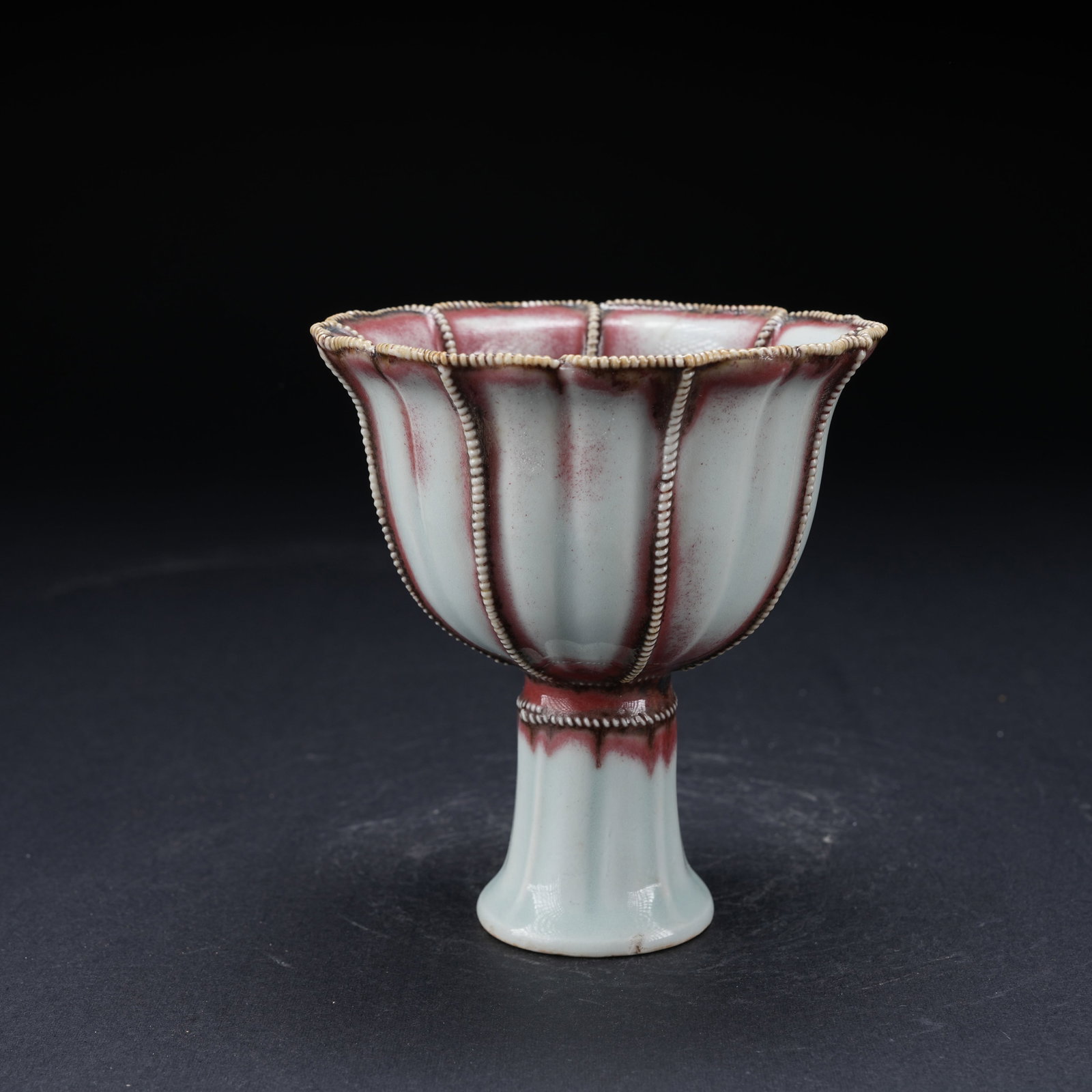A UNDERGLAZE RED TWISTED ROPE PATTERN TALL FOOTED CUP: Underglaze Red Twisted Rope Pattern Tall Footed Cup