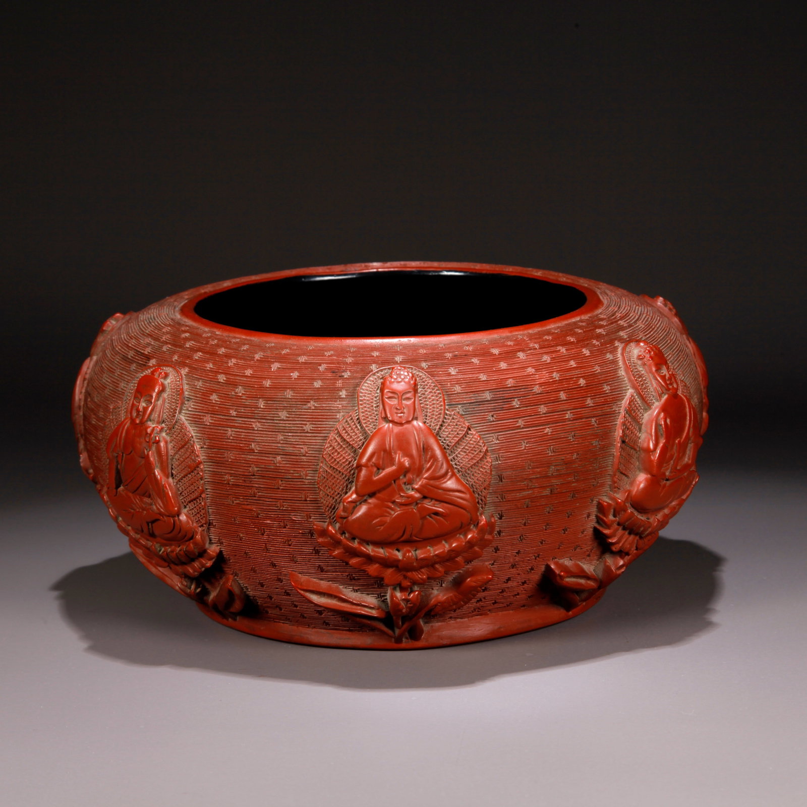 A CARVED RED LACQUER BOWL WITH BUDDHIST IMAGE PATTERN (1 of 10)