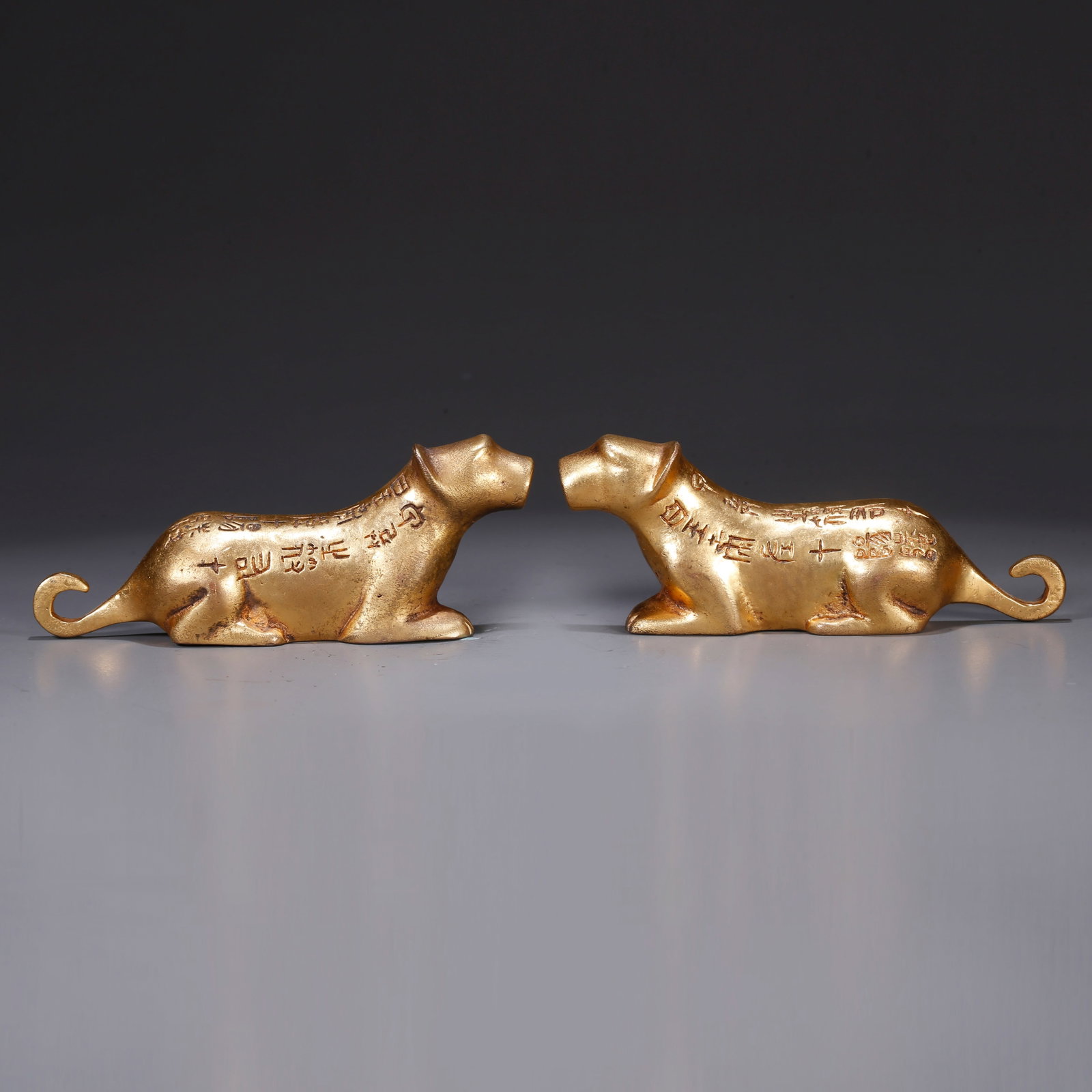 A GILT BRONZE TIGER TALLY (1 of 10)