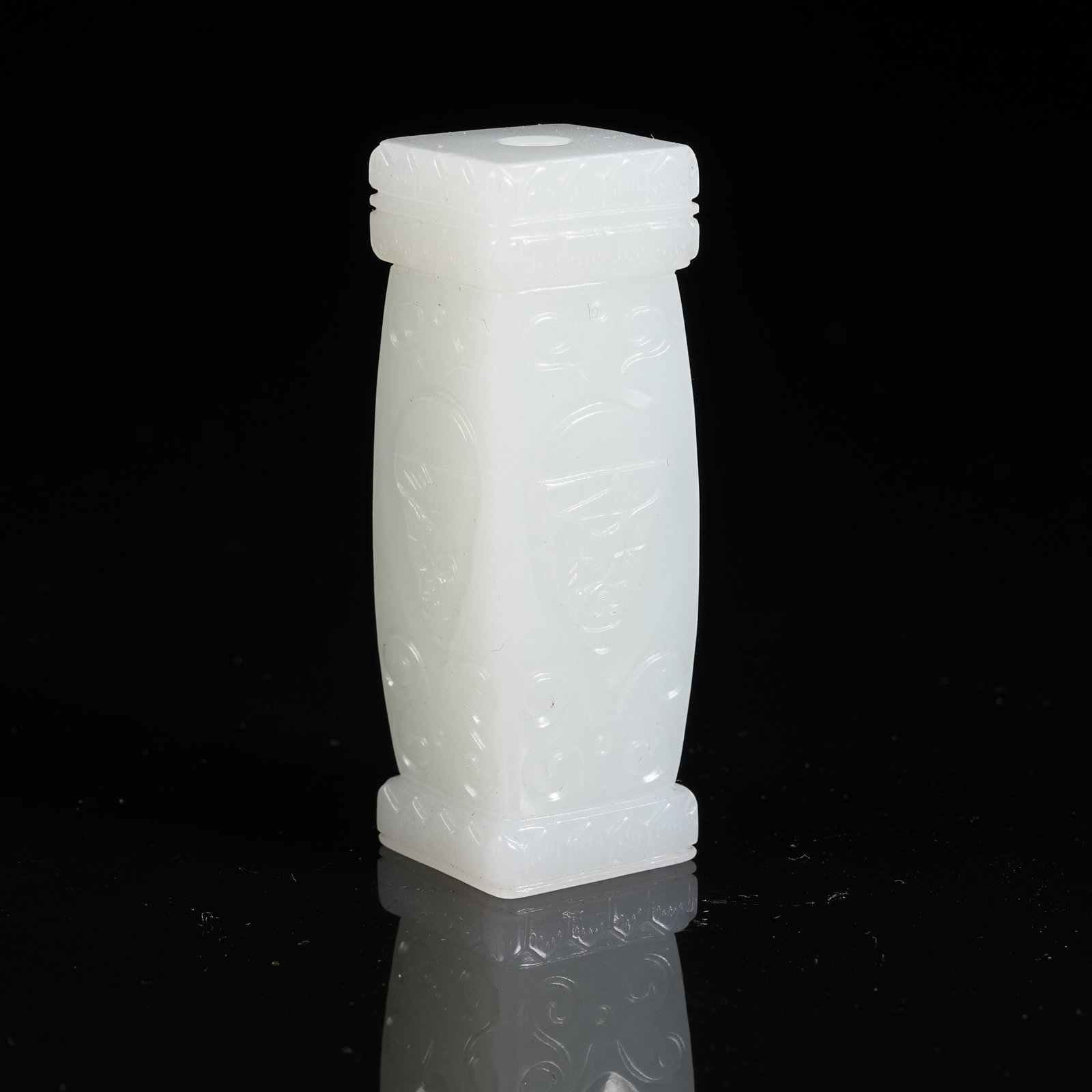 A HETIAN JADE CYLINDRICAL BEAD WITH BUDDHA PATTERN: Hetian Jade Cylindrical Bead with Buddha Pattern