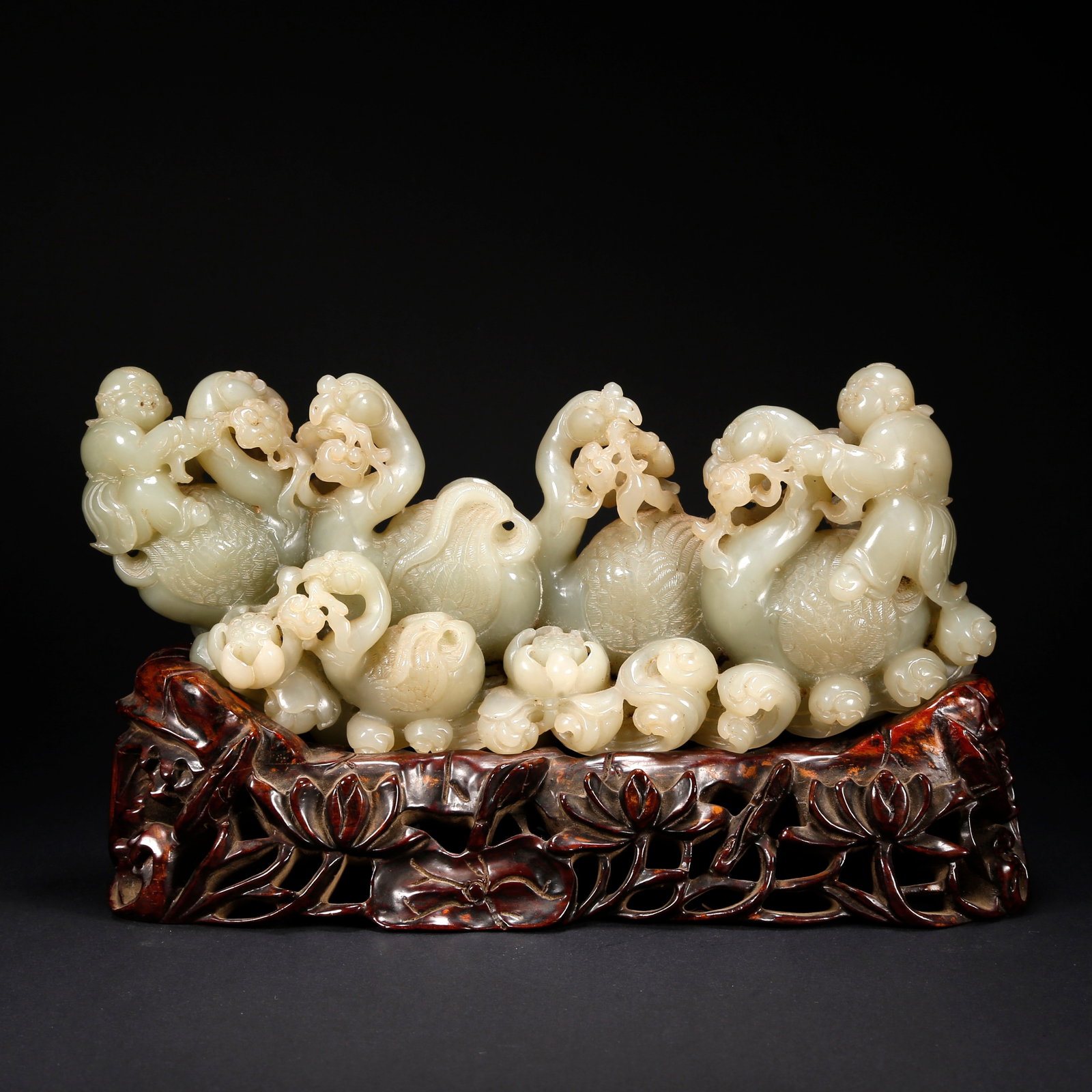 A HETIAN JADE CHILD PLAYING WITH GOOSE FIGURINE: Hetian Jade Child Playing with Goose Figurine