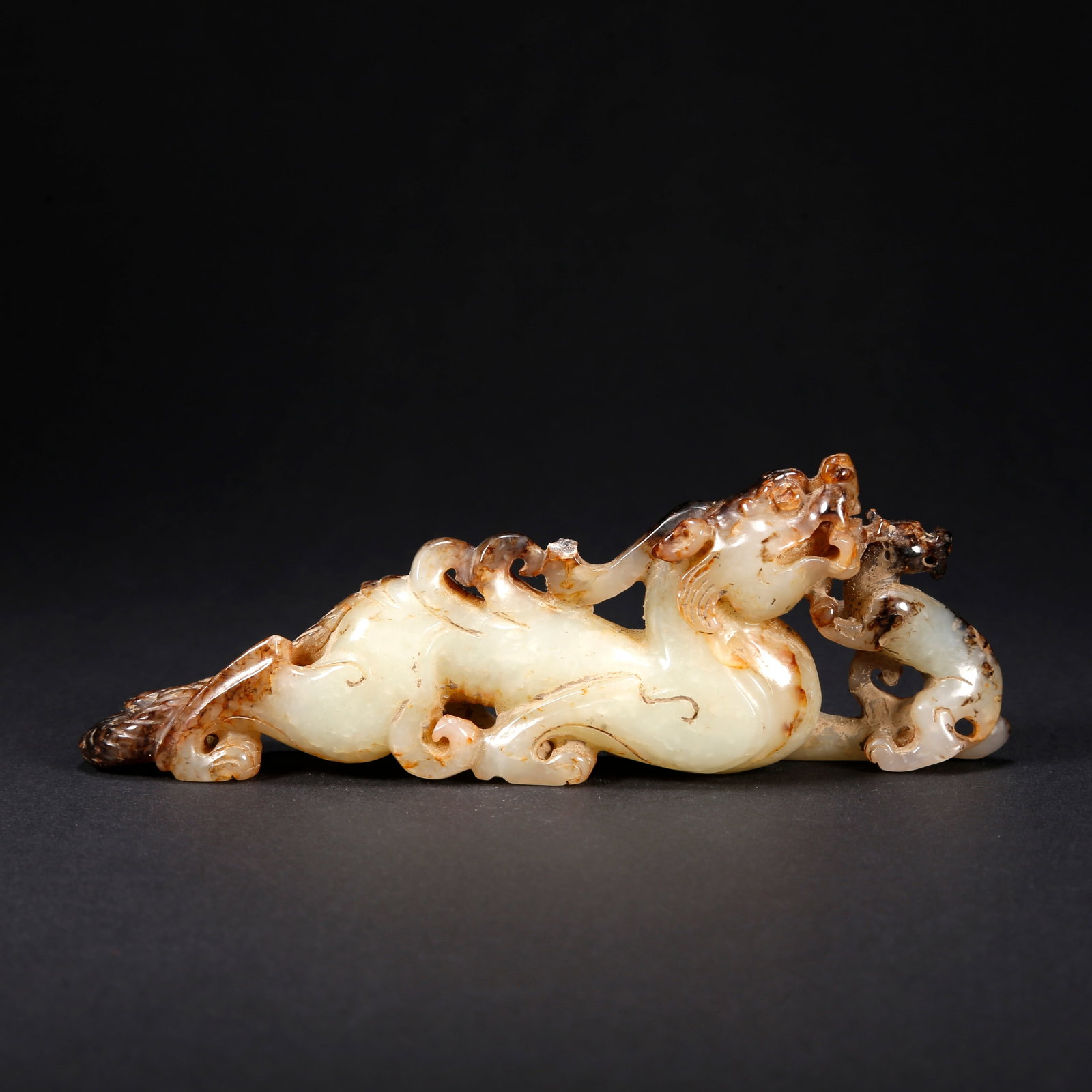 A HETIAN JADE BEAST-SHAPED FIGURINE: Hetian Jade Beast-Shaped Figurine
