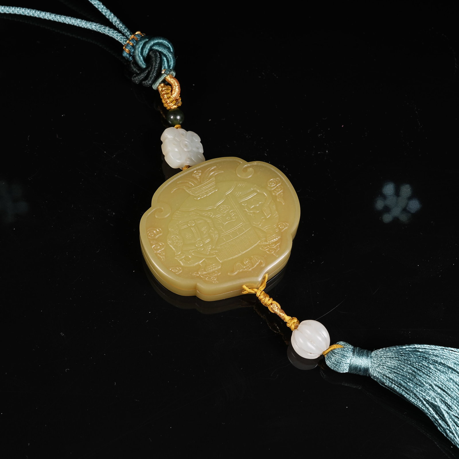 A HETIAN YELLOW JADE SACHET WITH PEACE AND ELEPHANT MOTIF: Hetian Yellow Jade Sachet with Peace and Elephant Motif