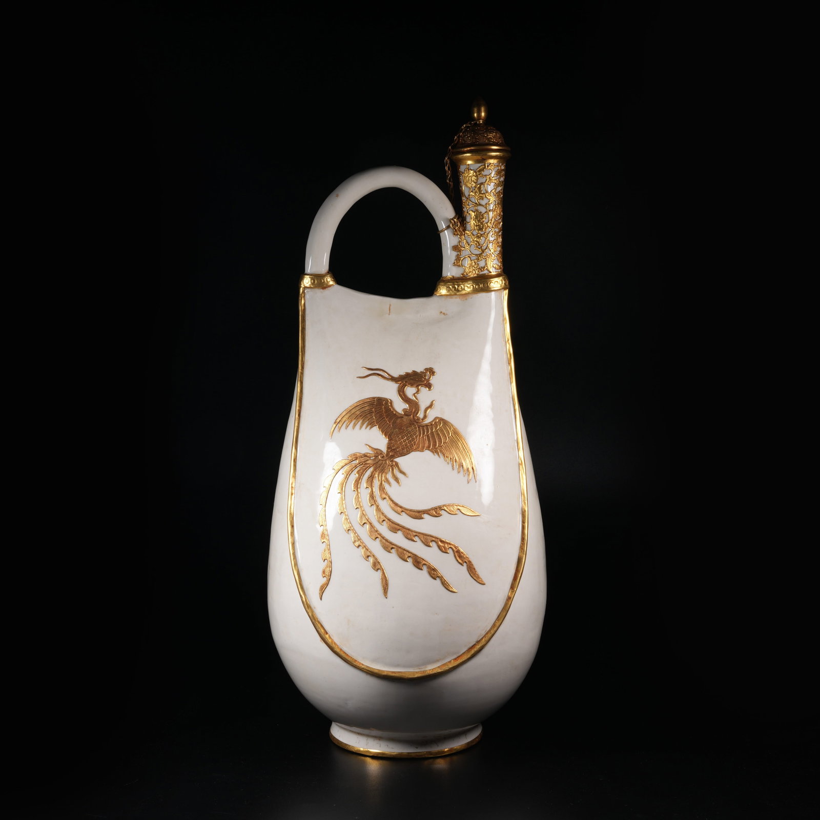 A DING KILN LEATHER POUCH POT WITH PHOENIX PATTERN: Ding Kiln Leather Pouch Pot with Phoenix Pattern