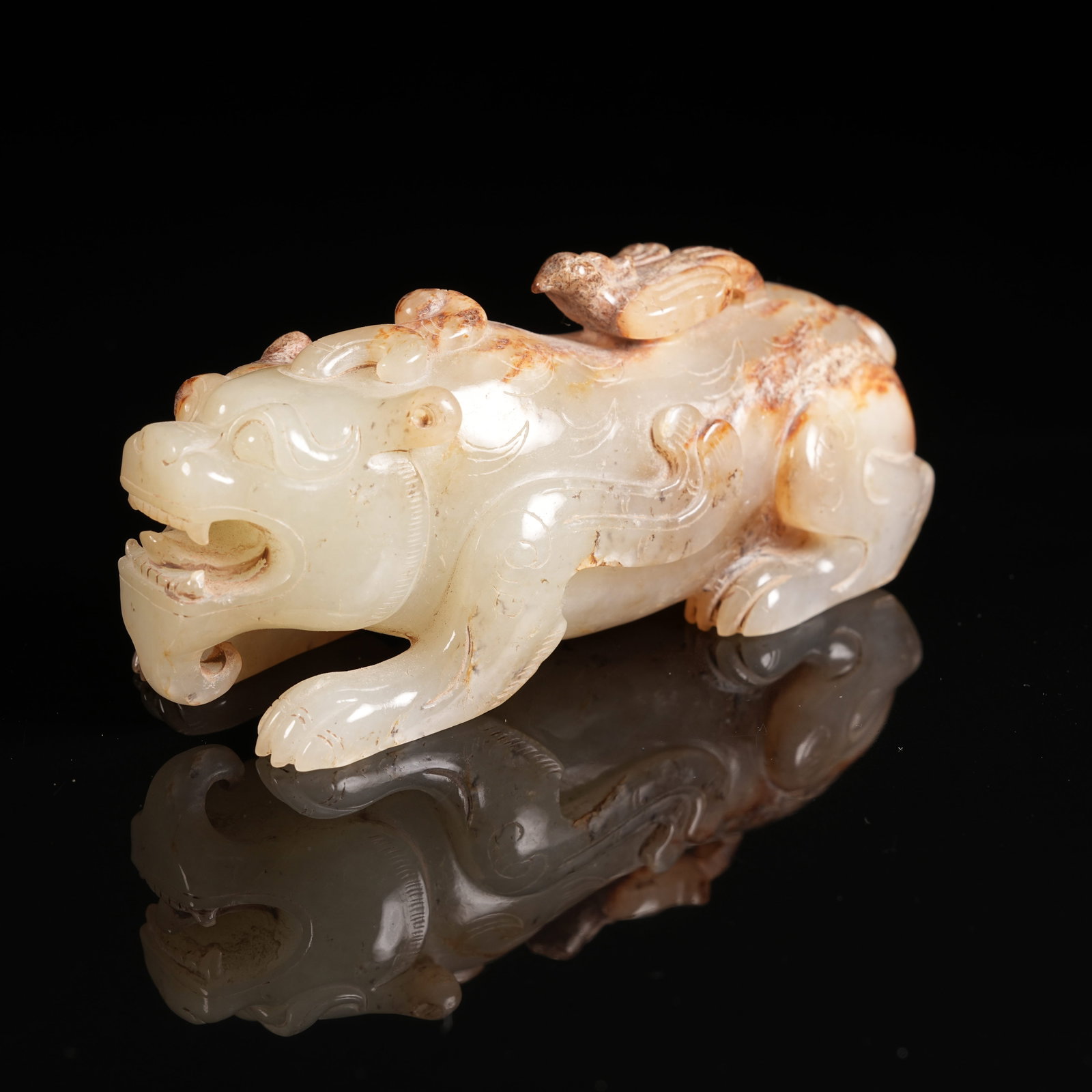 A ANCIENT JADE RECLINING AUSPICIOUS BEAST ORNAMENT: Ancient Jade Reclining Auspicious Beast Ornament