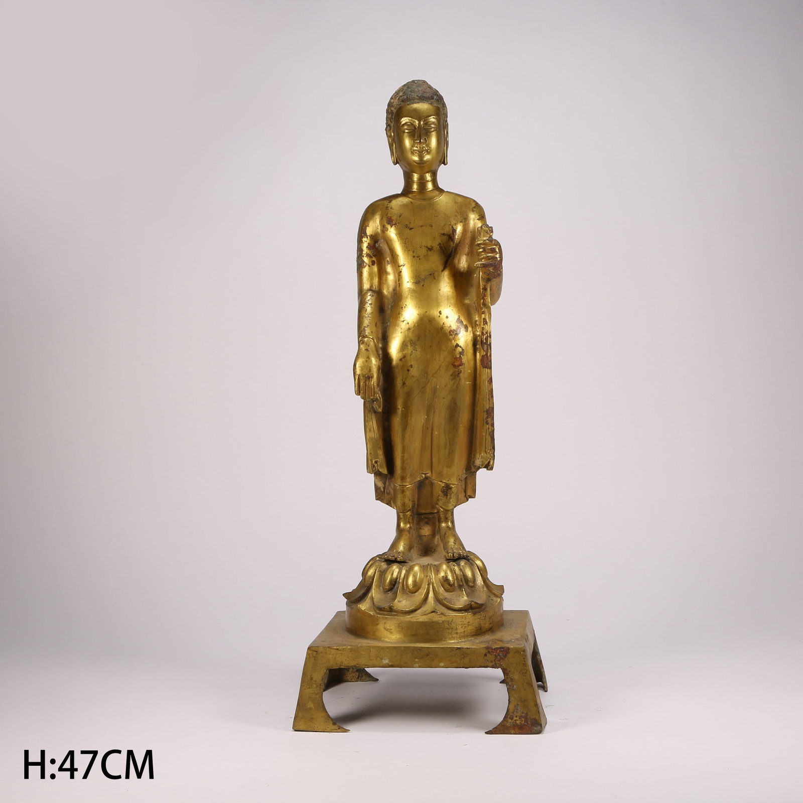 A GILT BRONZE STANDING BUDDHA (1 of 9)