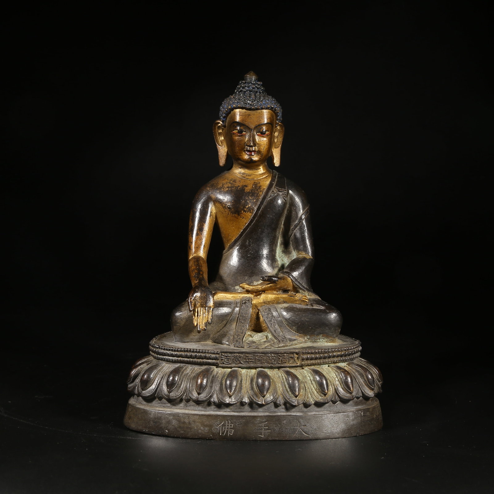 A BRONZE MUD-GILDED STATUE OF RATNASAMBHAVA: Bronze Mud-Gilded Statue of Ratnasambhava