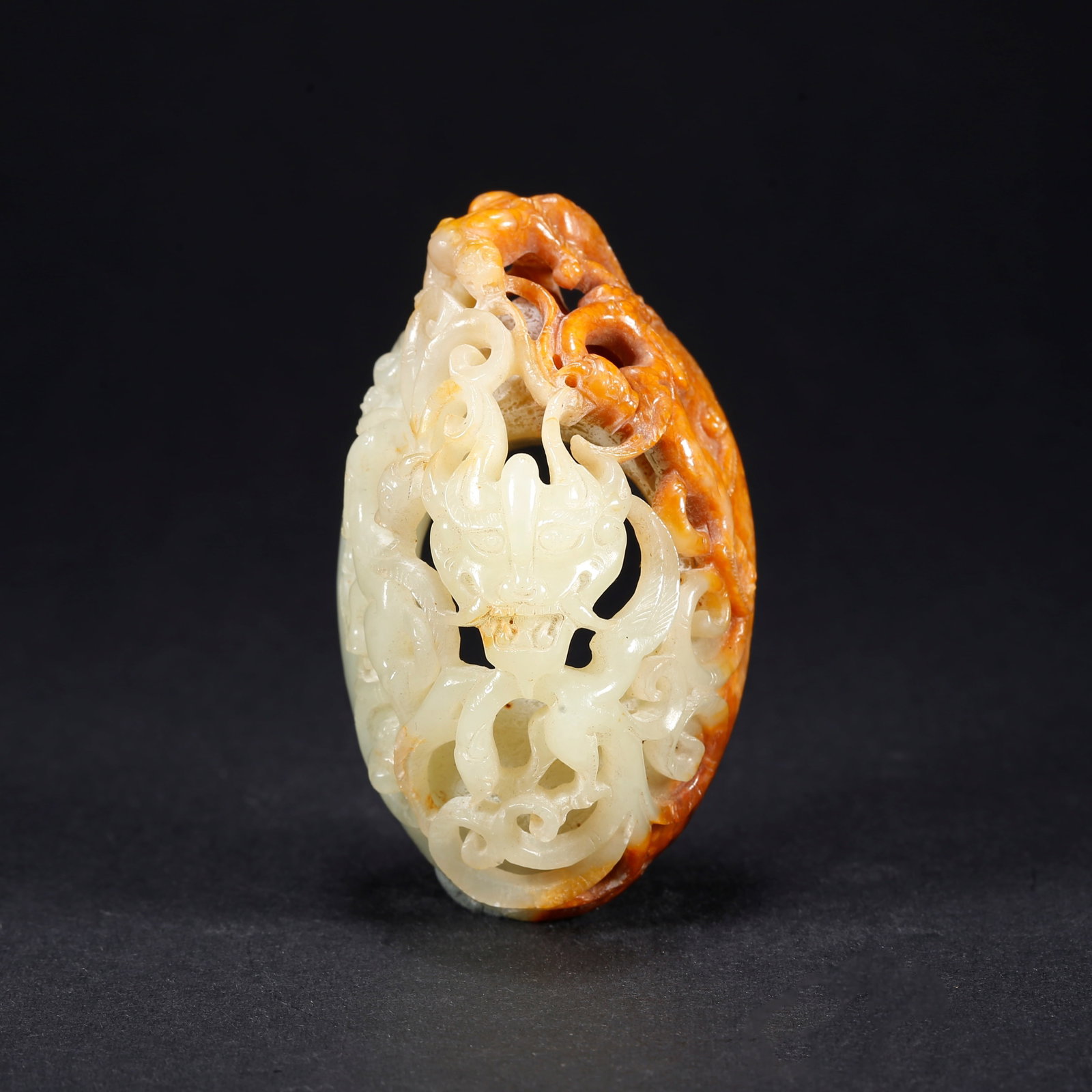 A HETIAN JADE CHICKEN-HEART PENDANT WITH DRAGON MOTIF (1 of 9)