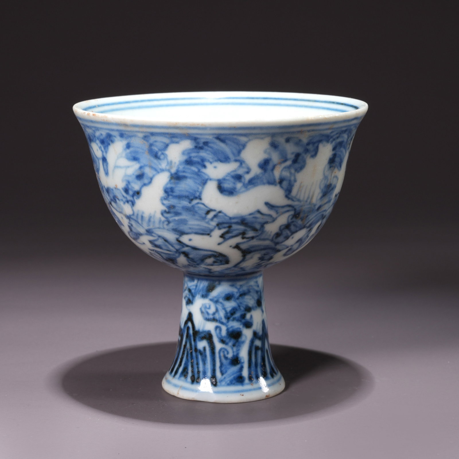 A BLUE-AND-WHITE HIGH-FOOTED CUP WITH BEAST MOTIFS: Blue-and-White High-Footed Cup with Beast Motifs