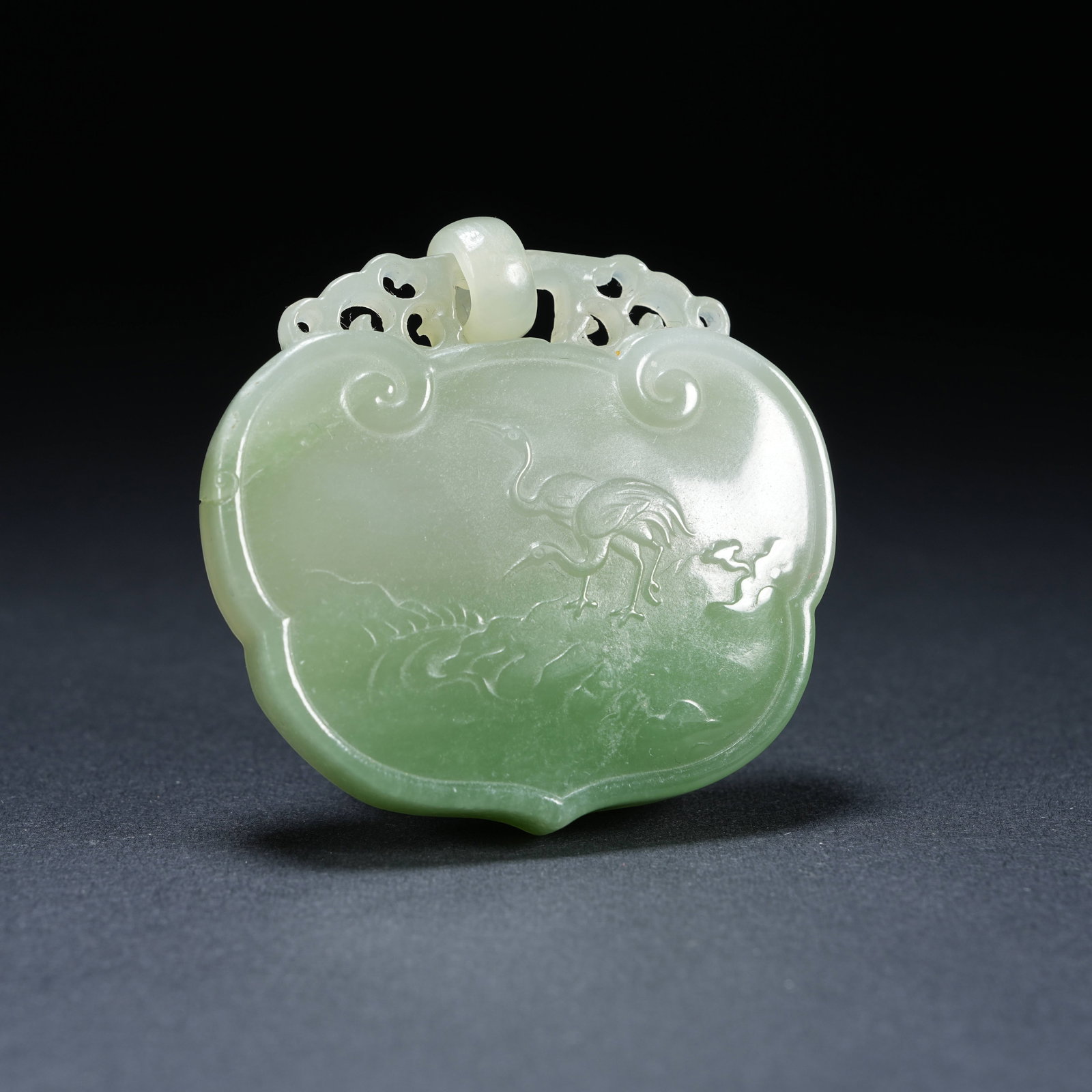 A HETIAN JADE COLOR-SCHEMED PEACE LOCK WITH PINE AND CRANE LONGEVITY PATTERN: Hetian Jade Color-schemed Peace Lock with Pine and Crane Longevity Pattern