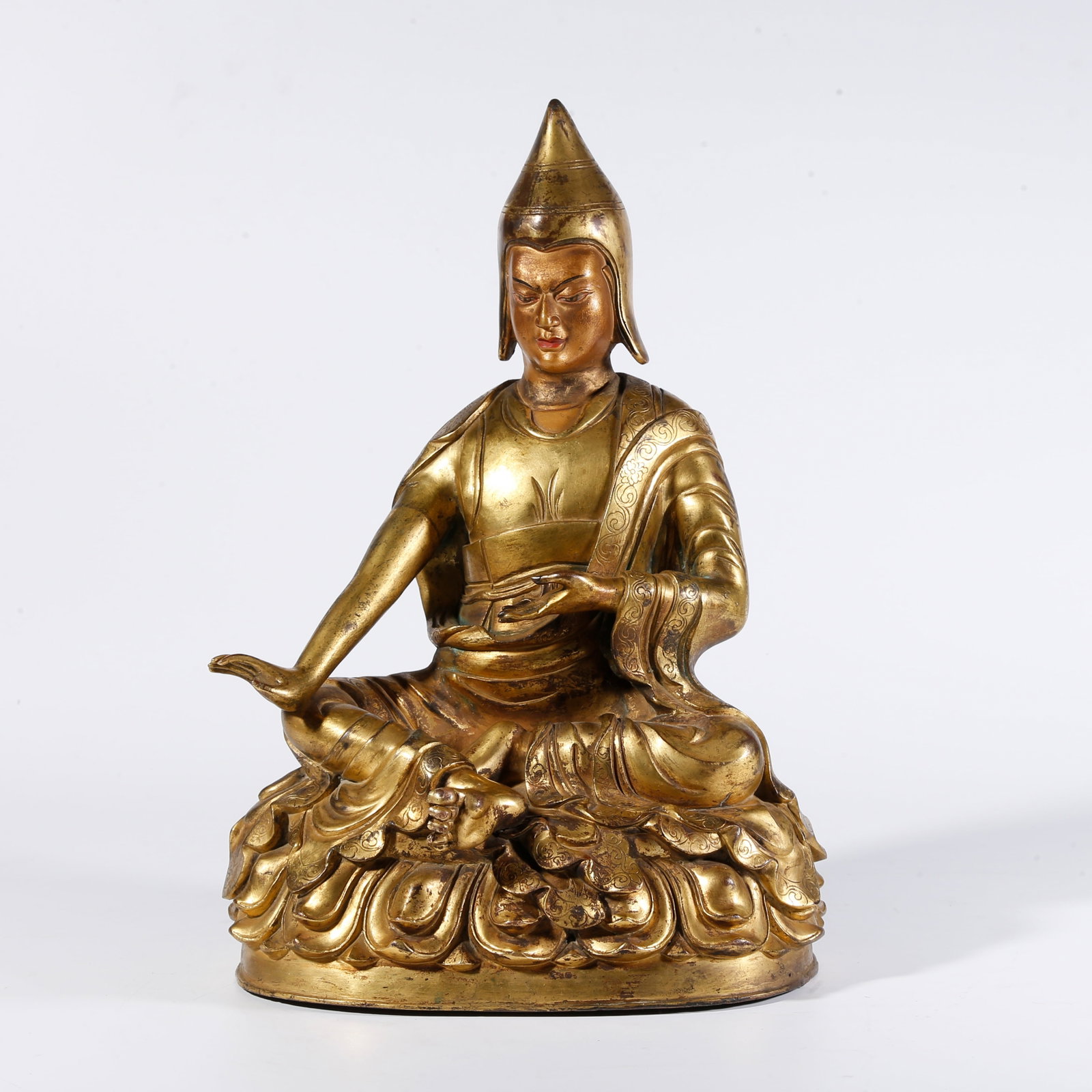 A GILT BRONZE STATUE OF A LAMA: Gilt Bronze Statue of a Lama