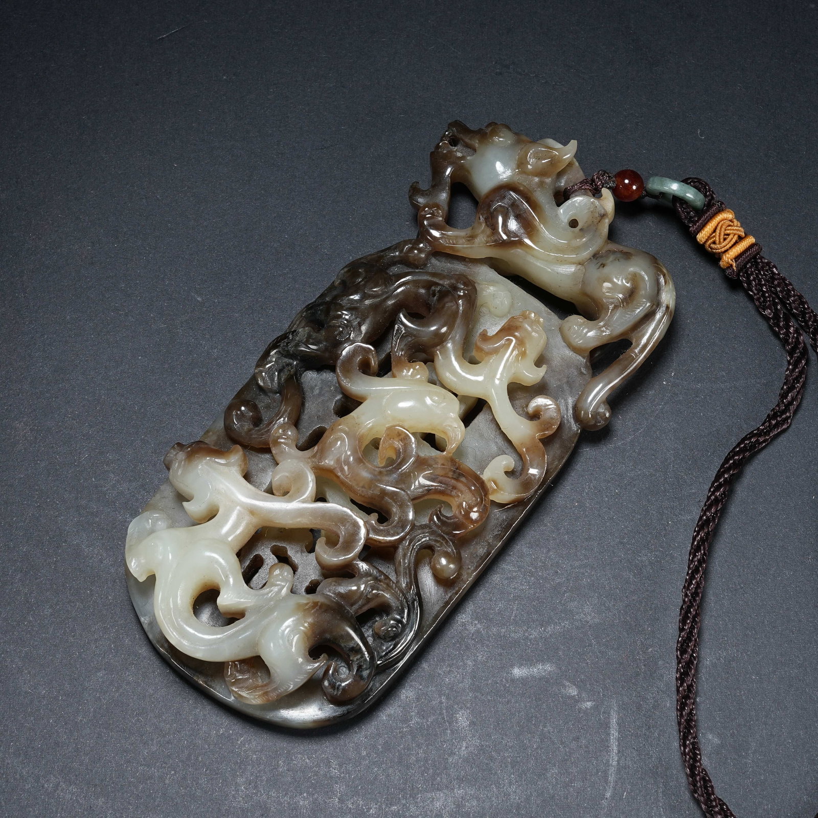 A HETIAN JADE BI DISC WITH TWO DRAGONS, ONE PHOENIX AND AUSPICIOUS BEAST MOTIF FOR DESCENDANT (1 of 9)